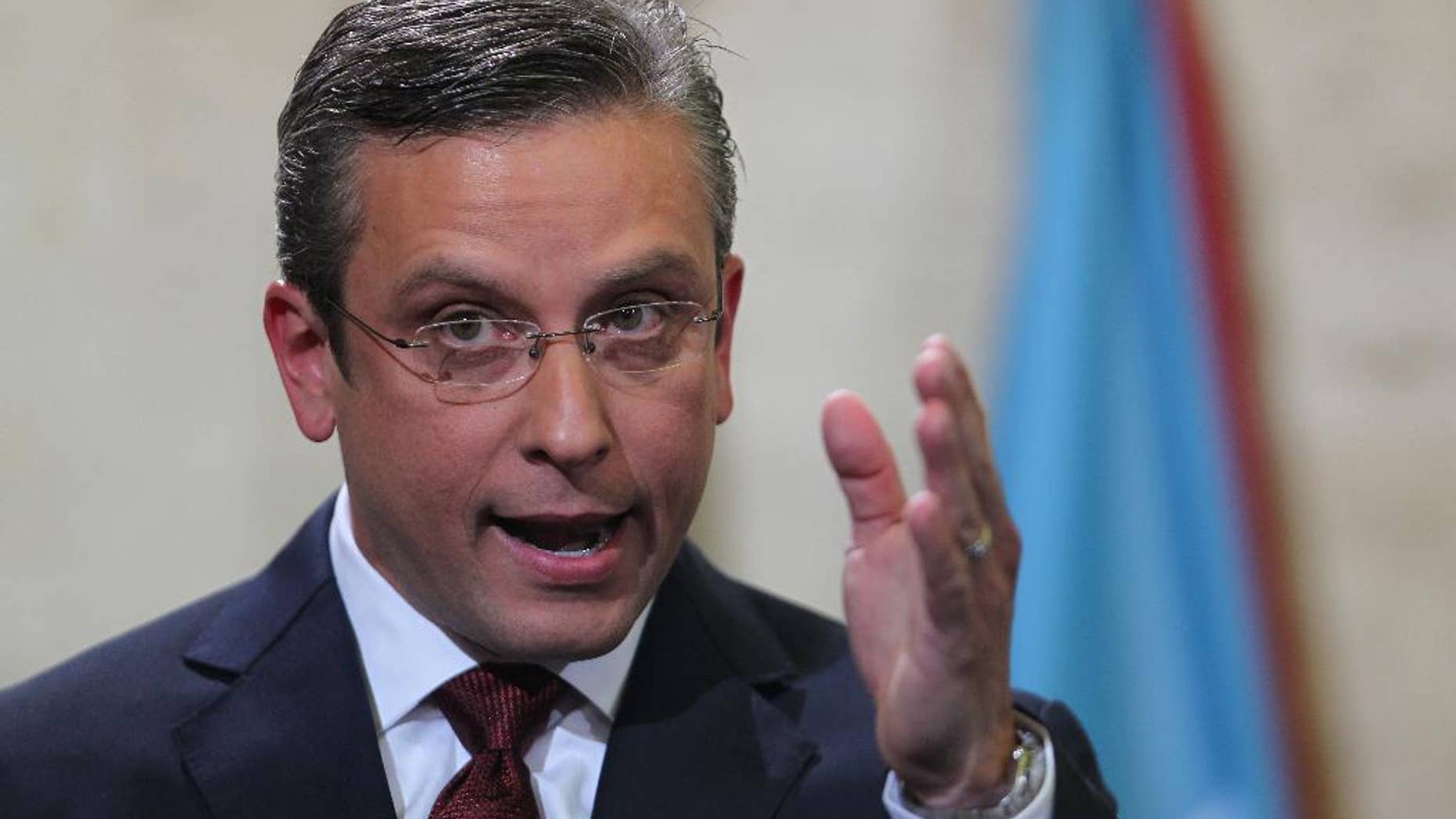 FILE- In this April 30, 2015, file photo, Puerto Rico Gov. Alejandro Garcia Padilla delivers his budget address for the next fiscal year at the Capitol building in San Juan. Puerto Rico's governor believes the U.S. territory's $72 billion public debt is unpayable, his spokesman confirmed late Sunday, June 28, 2015, adding another blow to the international financial system already struggling with a possible default by Greece. (AP Photo/Ricardo Arduengo, File)