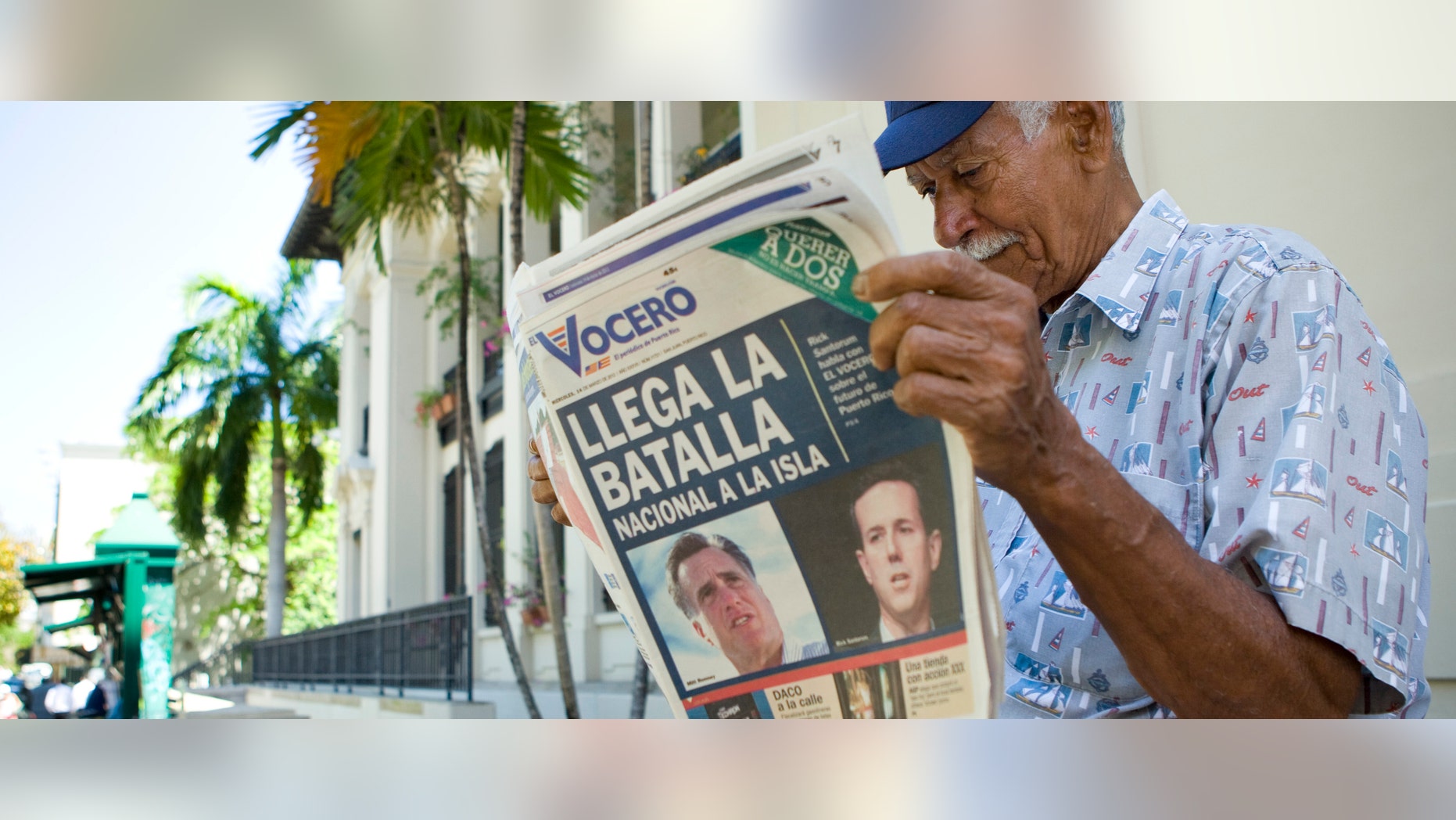 SAN JUAN, PUERTO RICO - MARCH 14: Carlos Diaz, 84, reads local newspaper El Vocero with a front page depicting both Mitt Romney and Rick Santorum and a headline reading, "The National Battle Arrives on the Island. (Photo by Christopher Gregory/Getty Images)