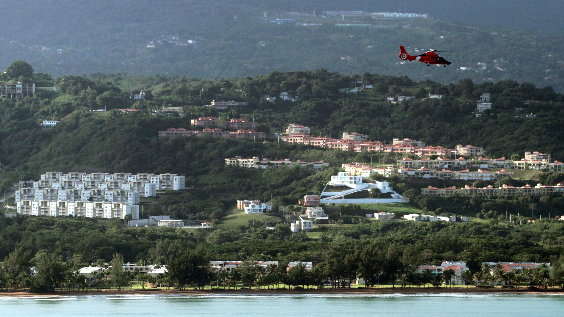 Dec. 21: A U.S. Coast Guard helicopter flies over an area believed to be the crash site of a Puerto Rico National Guard helicopter in Rio Grande, Puerto Rico. The Puerto Rico National Guard helicopter crashed into the ocean the previous day on a drug raid mission with six people aboard.