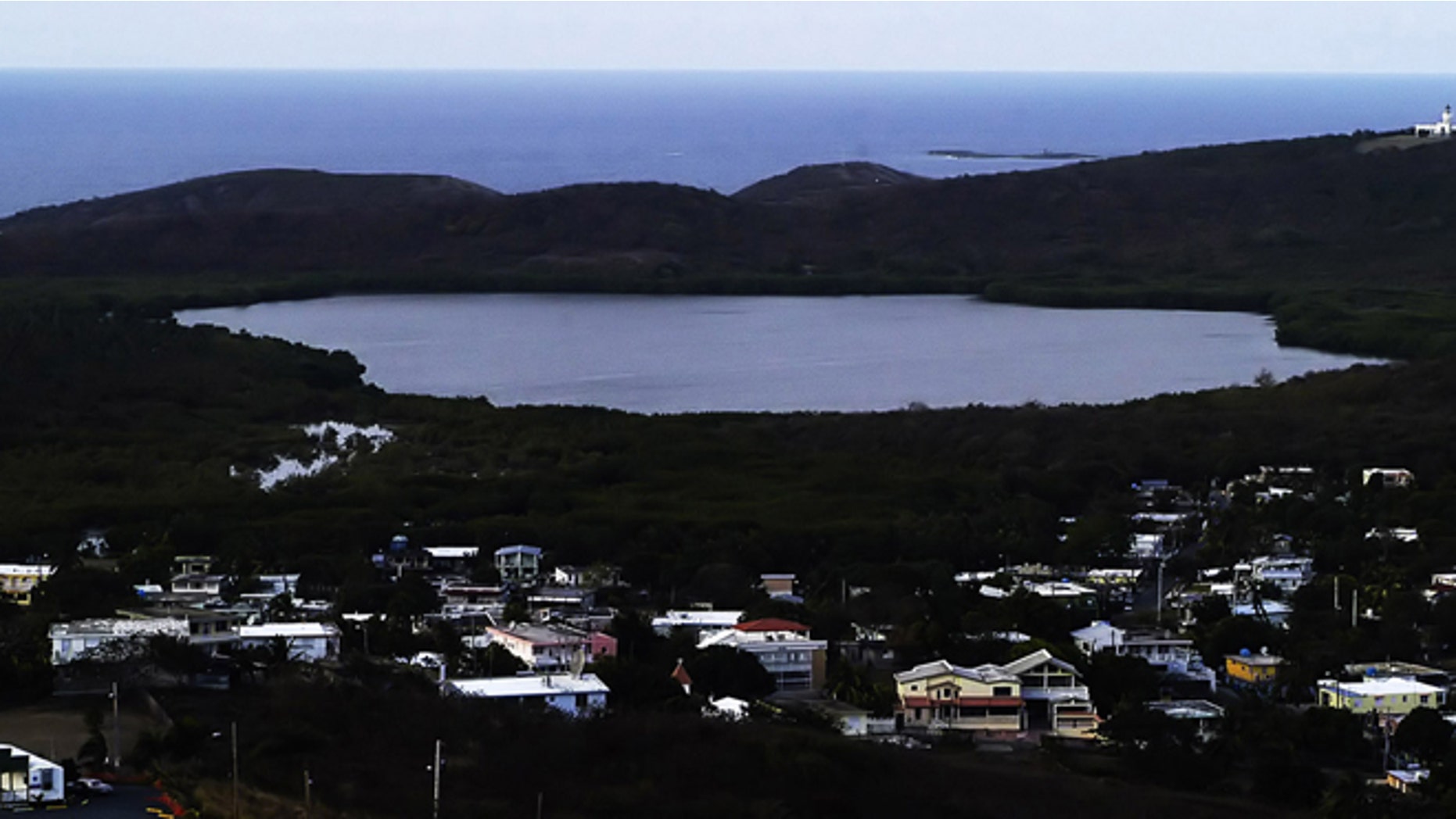 FILE - This April 1, 2005 file photo shows the Fajardo Grand Lagoon at the Nature Reserve of Las Cabezas de San Juan at dawn, about 35 miles east of San Juan, Puerto Rico. Biologists are investigating why the bioluminescent bay off the northeast coast off the Puerto Rican coast has lit up once again, Friday Dec. 6, 2013, as scientists wrap up their investigation into why it went dark last month, officials said Friday (AP Photo/Herminio Rodriguez, File)