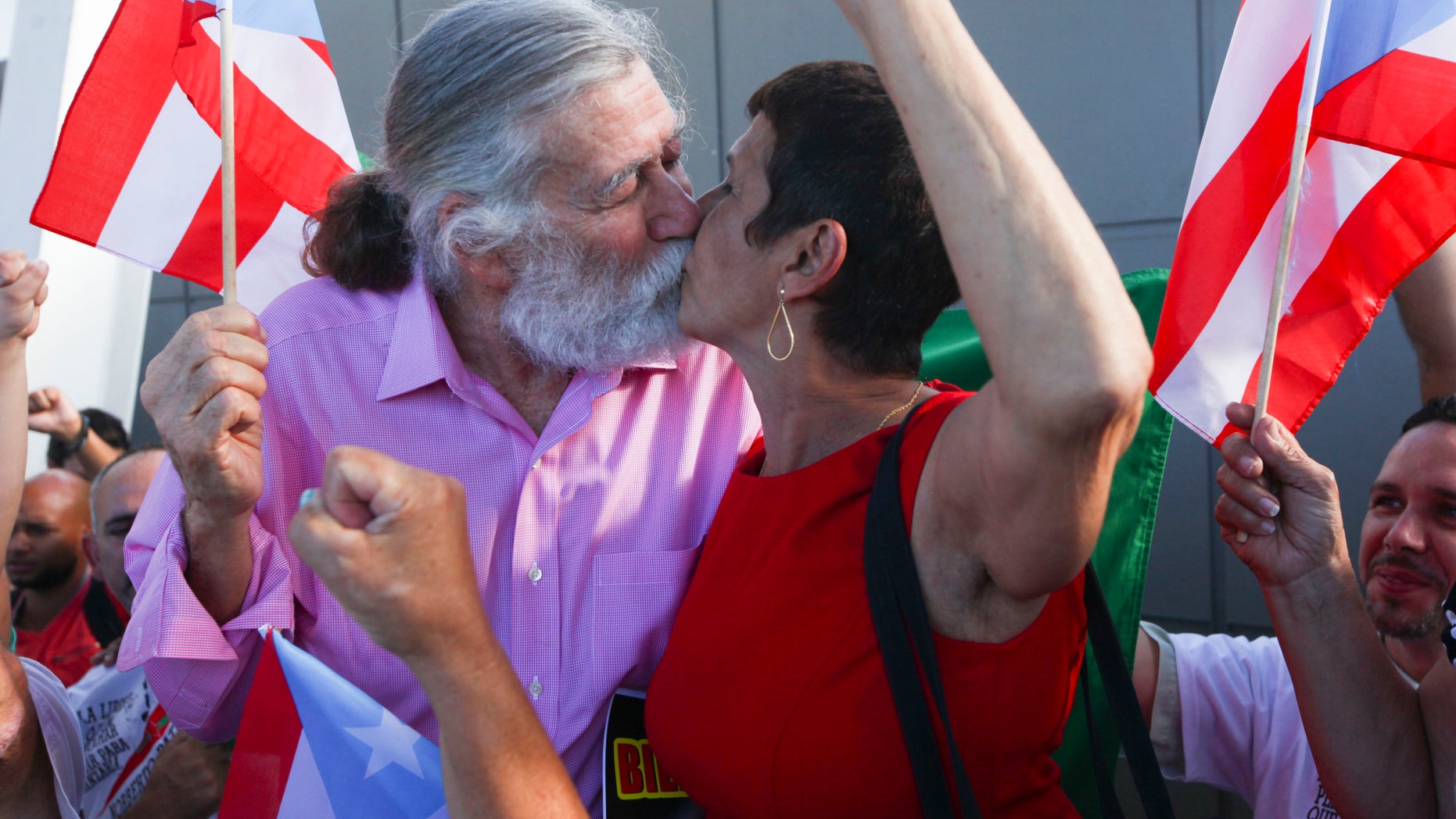 Norberto Gonzalez Claudio kisses his wife Elda Santiago in Carolina, Puerto Rico, Jan. 15, 2015.