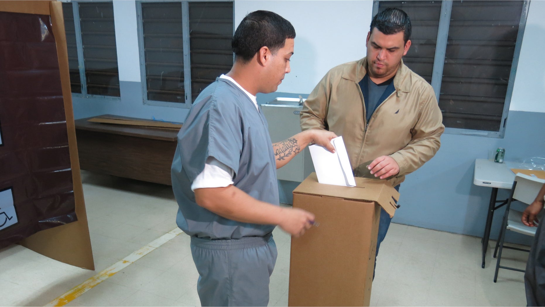 An inmate casts a vote in Puerto Rico's Republican primary at a prison in Bayamon, Puerto Rico, Friday, March 4, 2016. The U.S. territory has allowed inmates to vote since the 1980s. Residents of the island are not allowed to vote in U.S. general elections but are allowed to participate in primaries. (AP Photo/Danica Coto)