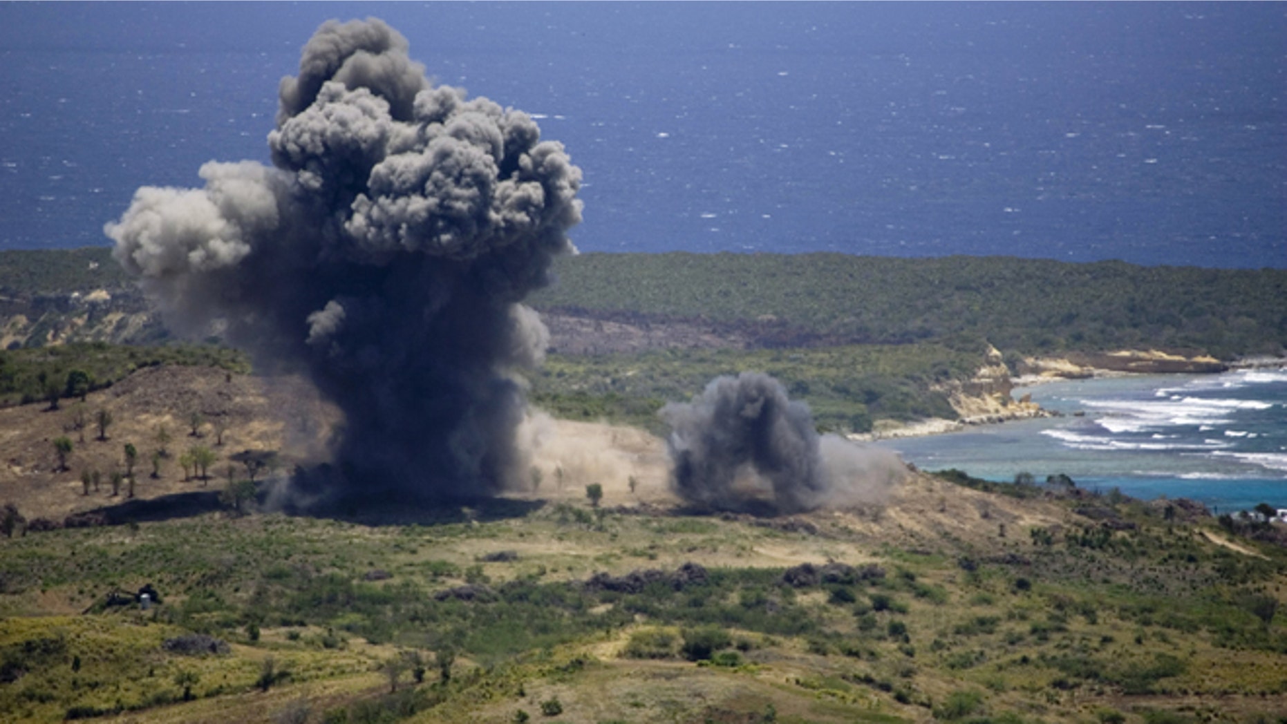 FILE - In this April 17, 2008 file photo, unexploded ordinance is blown up in a controlled demolition at the former U.S. Naval Training Range on Vieques island, Puerto Rico. A U.S. Agency has issued a long-awaited report saying it did not find any proof that decades of military activity in the Puerto Rican island of Vieques sickened residents who blame the federal government for high rates of cancer, asthma and other illnesses. (AP Photo/Brennan Linsley, File)