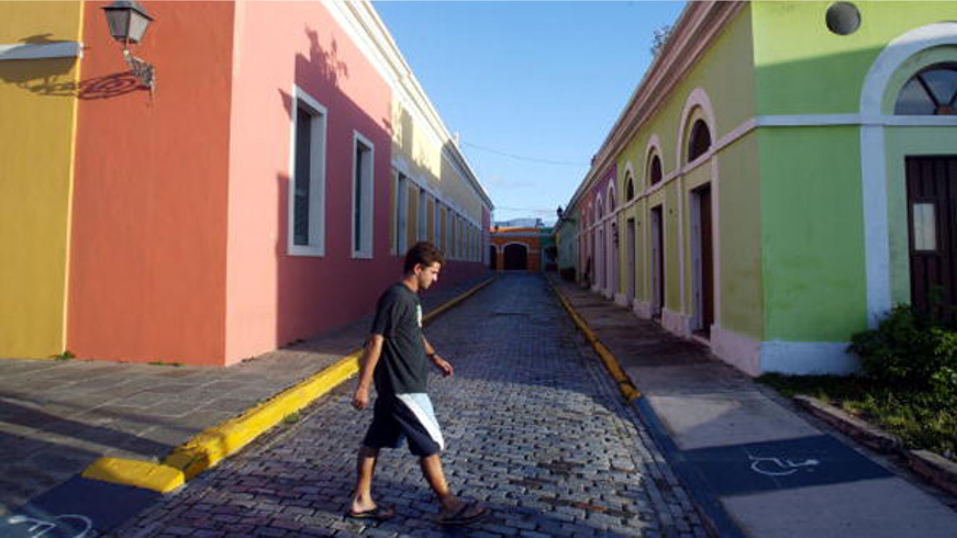 SAN JUAN, PUERTO RICO- APRIL 25: Colorful homes line the cobblestoned streets April 25, 2004 in Old San Juan, the original capital city of San Juan, Puerto Rico. The old city is a historic district of seven square blocks made up of ancient buildings and colonial homes, massive stone walls and vast fortifications, sunny parks and cobblestoned streets. (Photo by Joe Raedle/Getty Images)