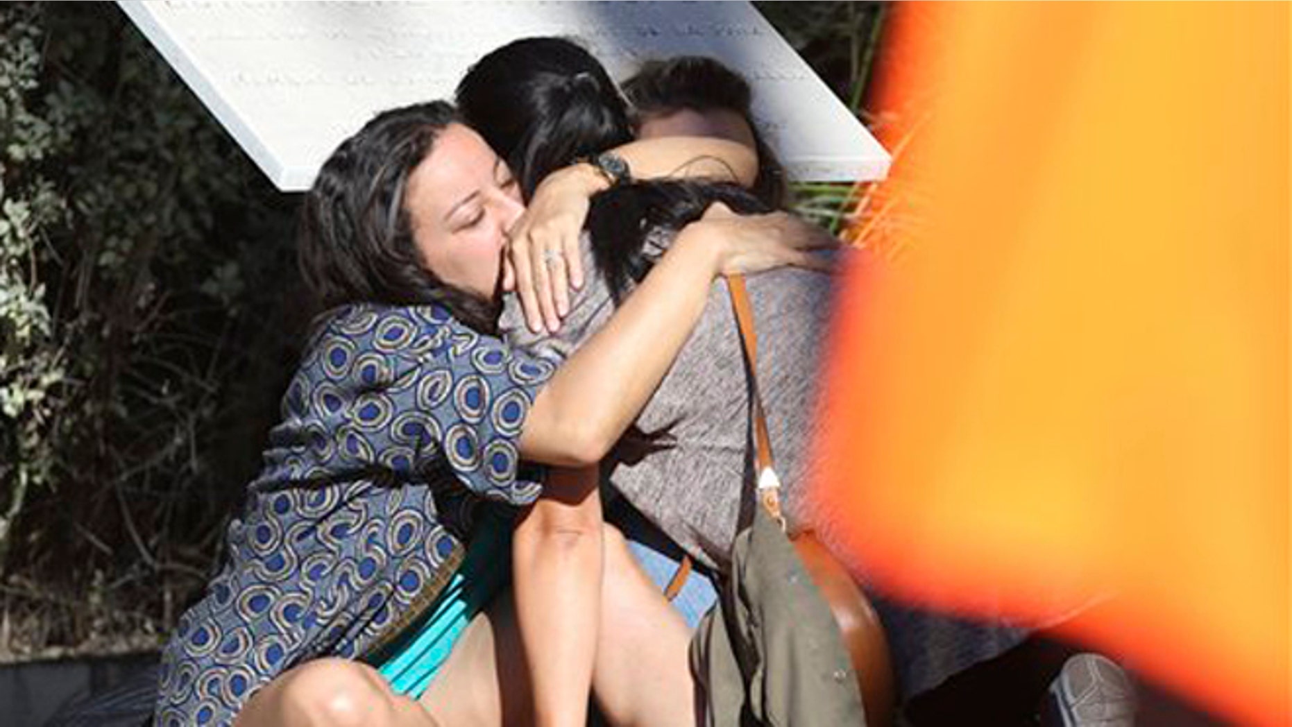 Parents of victims embrace each other near the scene of a truck attack in Nice, Friday, July 15, 2016.