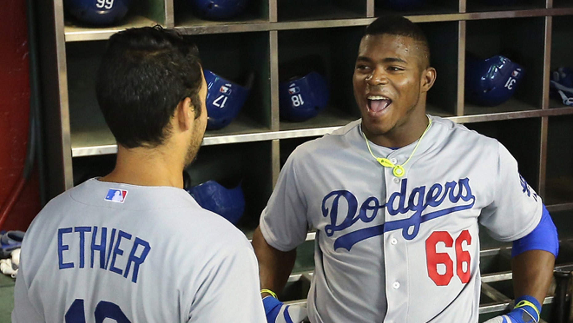 PHOENIX, AZ - APRIL 13: Yasiel Puig #66 of the Los Angeles Dodgers talks with Andre Ethier #16 in the dugout before the MLB game against the Arizona Diamondbacks at Chase Field on April 13, 2014 in Phoenix, Arizona. The Dodgers defeated the Diamondbacks 8-6. (Photo by Christian Petersen/Getty Images) *** Local Caption *** Yasiel Puig; Andre Ethier