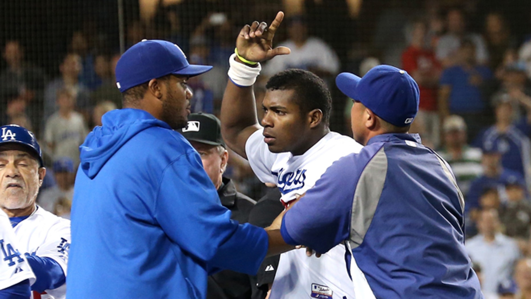 LOS ANGELES, CA - JUNE 11: Yasiel Puig #66 of the Los Angeles Dodgers is restrained by teammates during a benches clearing brawl after Zack Greinke was hit by a pitch in the seventh inning against the Arizona Diamondbacks at Dodger Stadium on June 11, 2013 in Los Angeles, California. Puig had been hit earlier in the game. (Photo by Stephen Dunn/Getty Images)