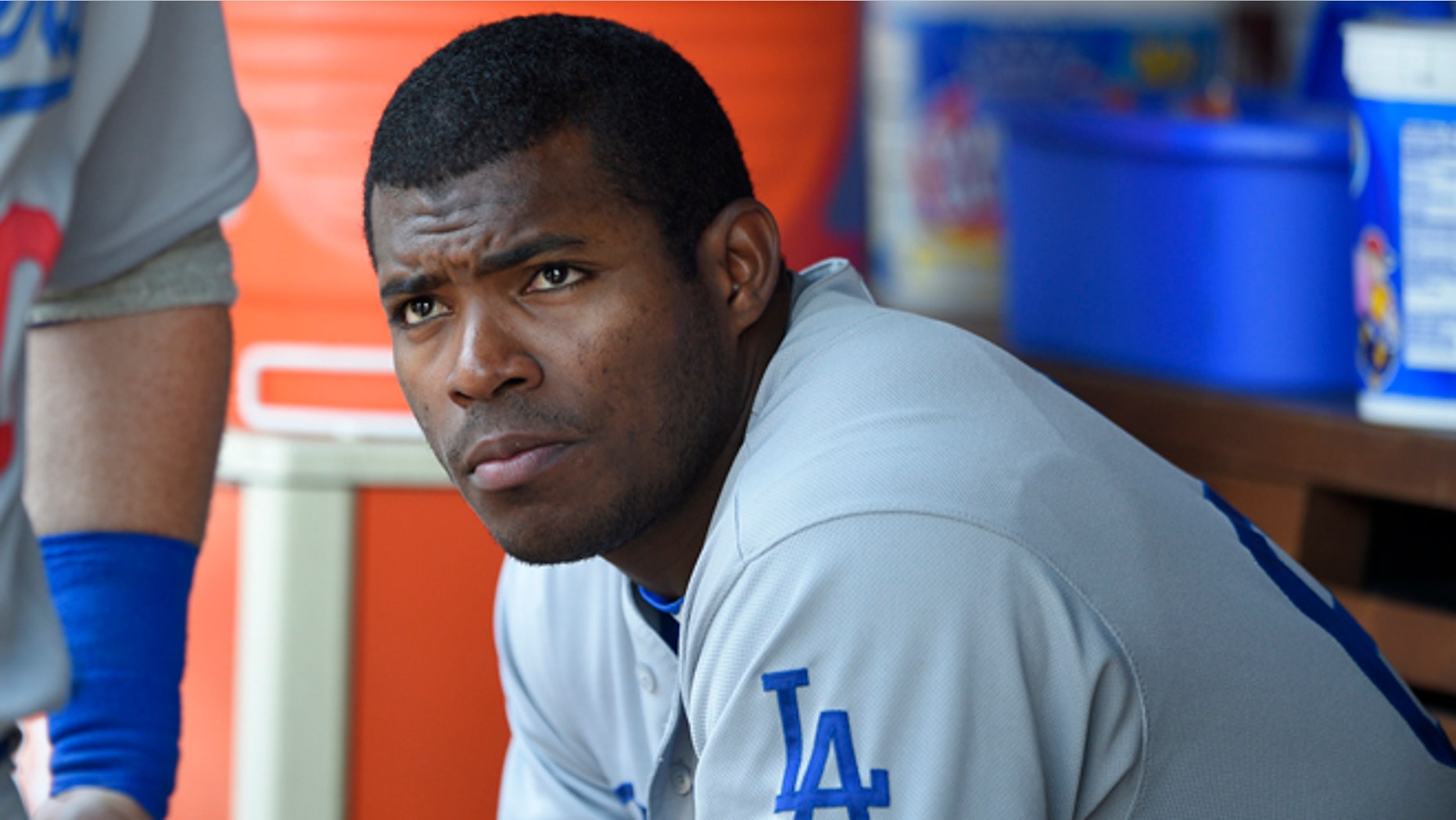FILE - This July 21, 2016 file photo shows Los Angeles Dodgers' Yasiel Puig looking on from the dugout during a baseball game against the Washington Nationals in Washington. Puig's agent said Monday, Aug. 1, 2016 the Los Angeles Dodgers slugger expects to be sent to the minors after the club was unable to trade him at the deadline. (AP Photo/Nick Wass)