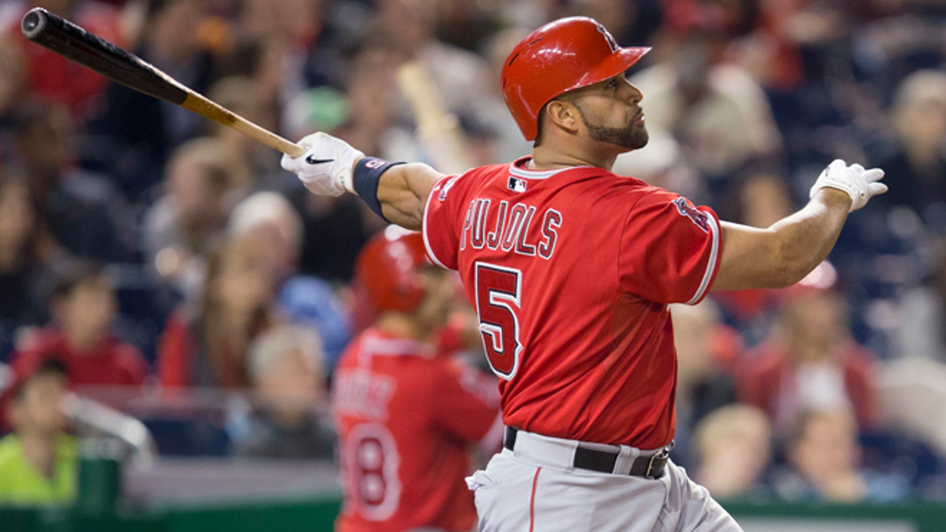 Los Angeles Angels Albert Pujols watches the ball after connecting for a two-run homer against Washington Nationals Taylor Jordan in the fifth inning of a baseball game in Washington, Tuesday, April 22, 2014. This was Pujols 500th career home run. (AP Photo/Pablo Martinez Monsivais)