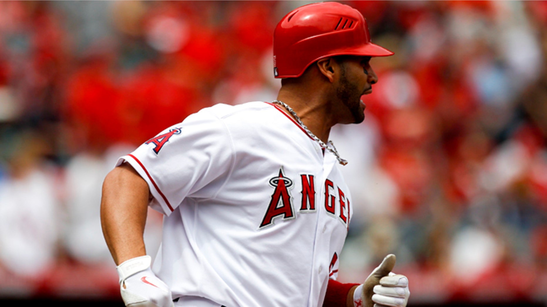 Los Angeles Angels' Albert Pujols reacts after flying out against the Baltimore Orioles during the first inning of a baseball game in Anaheim, Calif., Sunday, April 22, 2012. (AP Photo/Chris Carlson)