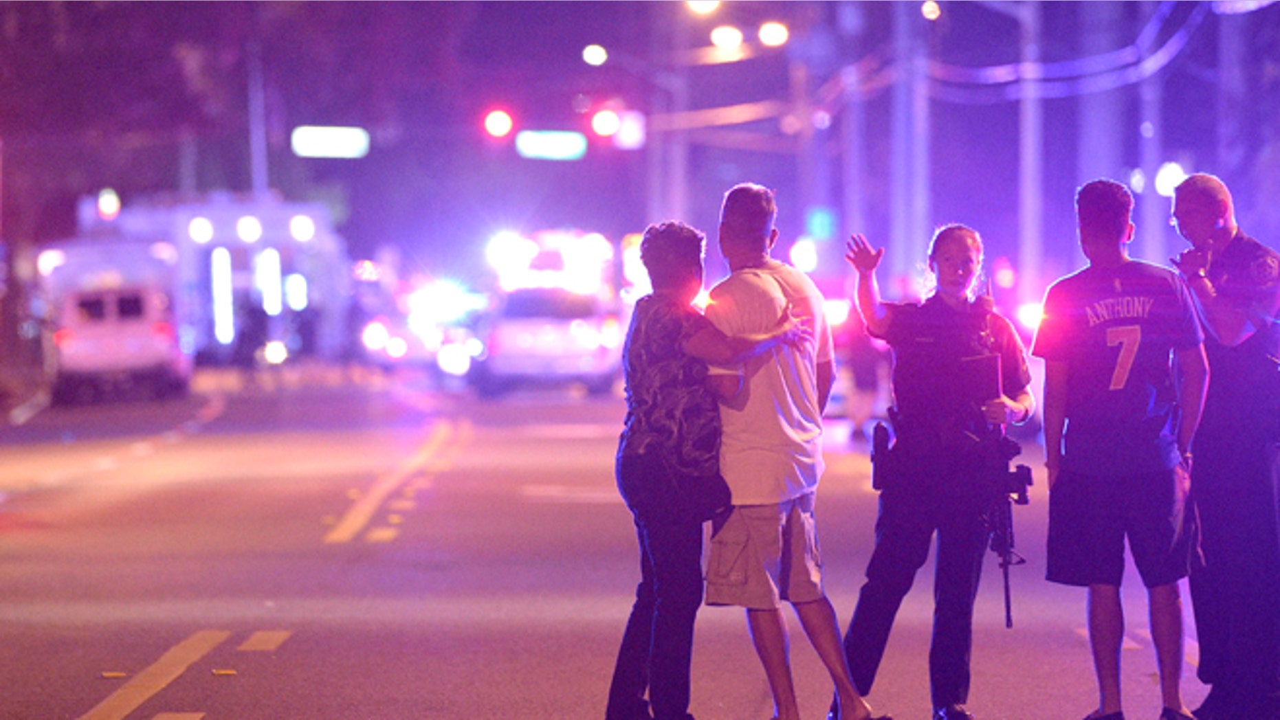 Orlando Police officers direct family members away from a multiple shooting at a nightclub in Orlando, Fla., Sunday, June 12, 2016. A gunman opened fire at a nightclub in central Florida, and multiple people have been wounded, police said Sunday. (AP Photo/Phelan M. Ebenhack)