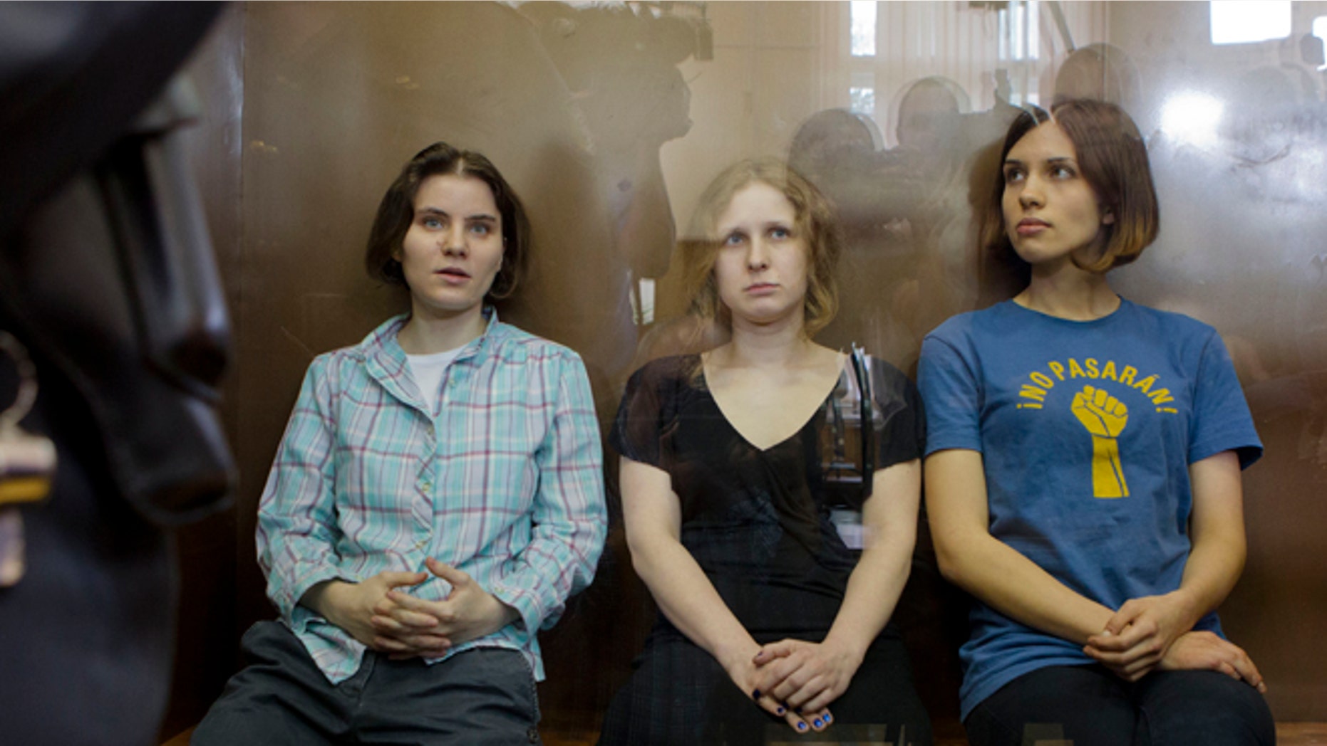 Aug. 17: Feminist punk group Pussy Riot members, Nadezhda Tolokonnikova, right, Maria Alekhina, center, and Yekaterina Samutsevich, sit in a glass cage at a court room in Moscow.
