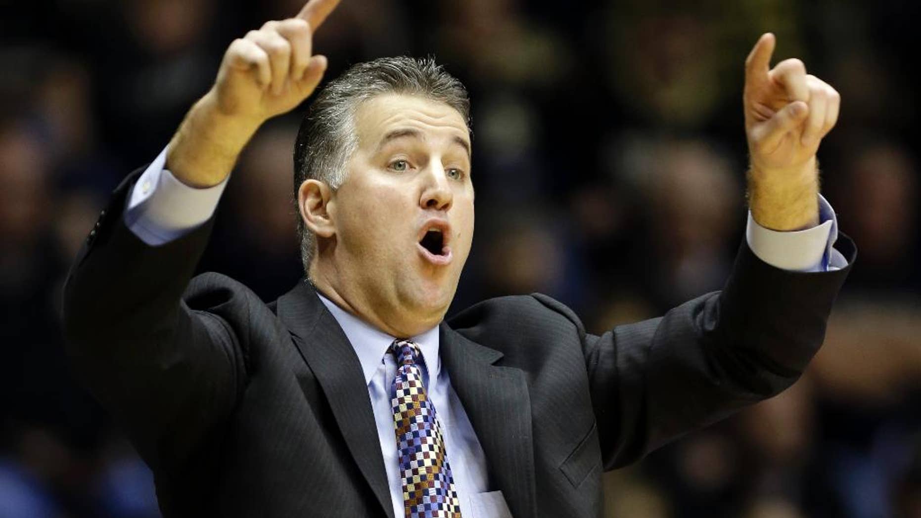 FILE - In this Jan. 12, 2014, file photo, Purdue head coach Matt Painter calls a play for his team as they play Nebraska in the second half of an NCAA college basketball game in West Lafayette, Ind. After losing 35 games over the past two seasons and finishing last in the Big Ten in 2013-14, Painter is going old-school. He wants to bring back the blue-collar, overachieving culture that made the Boilermakers so good for so many years. (AP Photo/Michael Conroy, File)