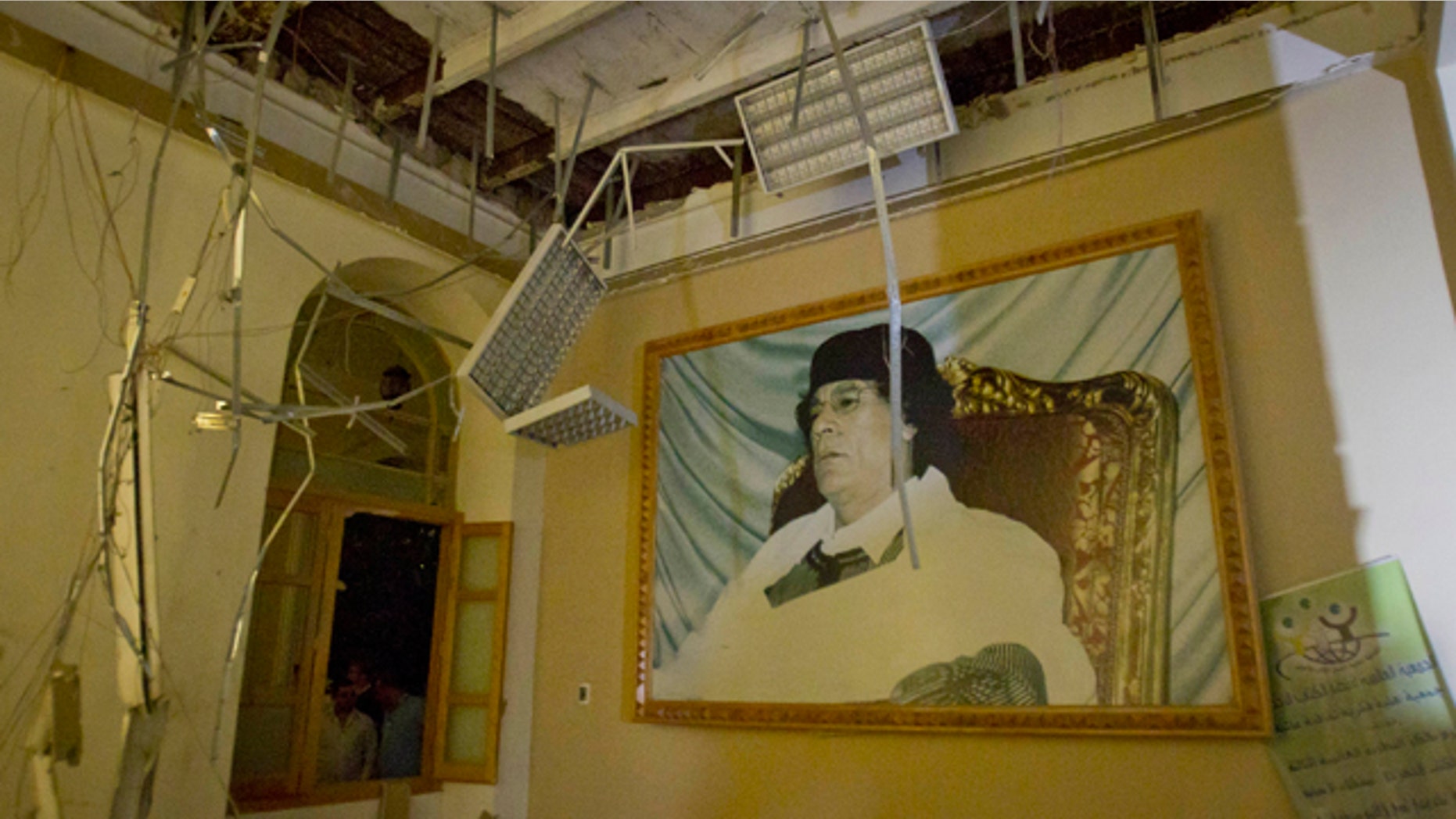 April 30: In this photo made on a government organized tour, a portrait of Moammar Gadhafi is seen inside damaged official building following an airstrike in Tripoli, Libya.