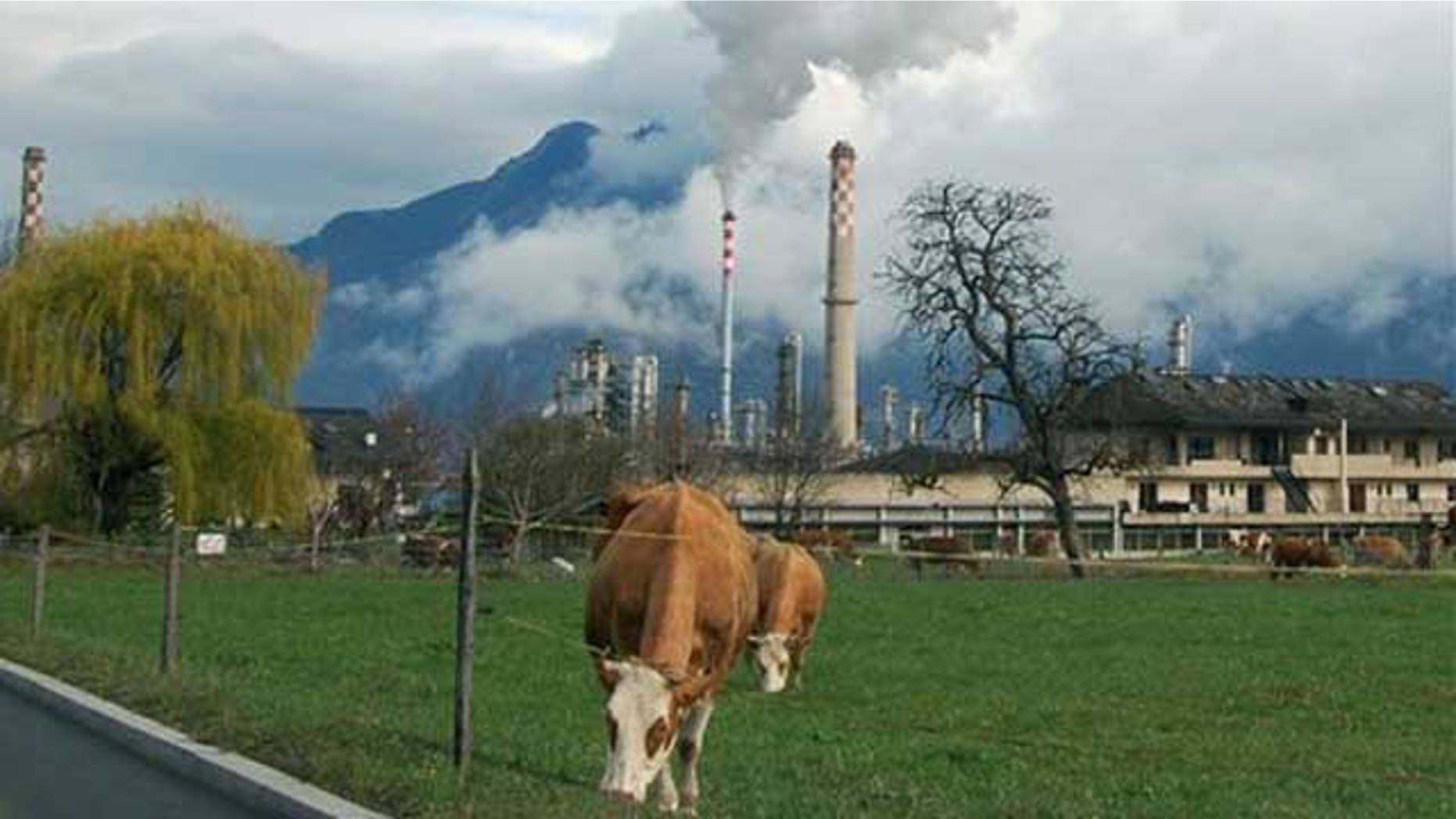 Smoke rises from the Libyan-owned Tamoil oil refinery in Collombey-Muraz, on Wednesday, March 30, 2011, on the eastern tip of Lake Geneva, Switzerland. The refinery is evidence of Libyan leader Moammar Gadhafi's strong foothold in Europe, as Tamoil has been allowed to continue operating unchecked despite the fact that its parent company is on a United Nations sanctions list and some experts including Zurich-based money-laundering expert Michael Alkalay, say European governments are being naive, or simply self-serving, in an attempt to protect European jobs and oil supplies.