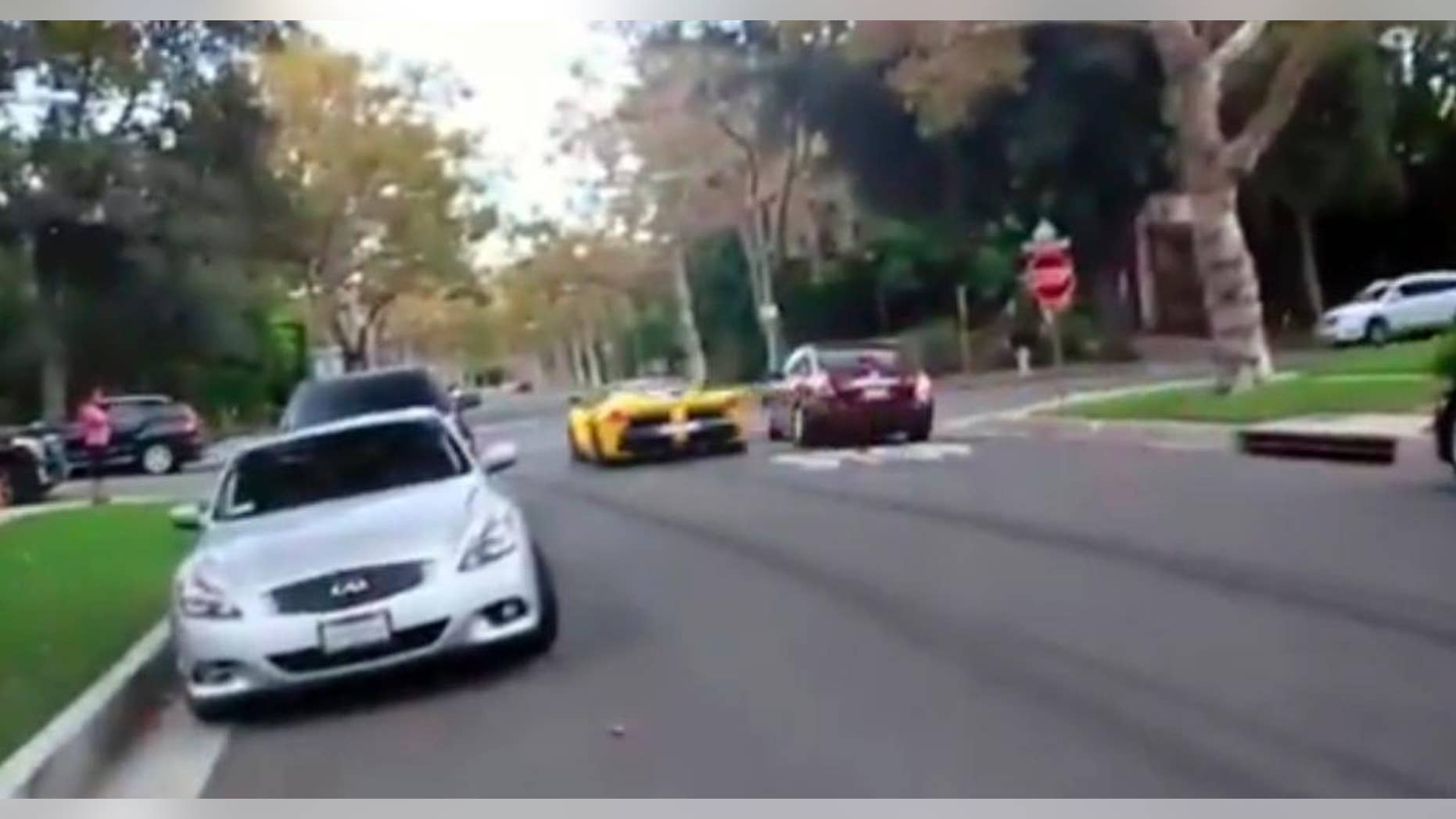 This frame grab from a video shows a yellow Ferrari speeding through a stop sign, Thursday, Sept. 17, 2015, in Beverly Hills, Calif. A Middle Eastern sheikh who allegedly said he owned a Ferrari caught on film speeding through a Beverly Hills neighborhood apparently has raced out of town, police said Thursday. Khalid bin Hamad Al Thani of Qatar has left the country and the cars are gone, authorities said at a news conference. (AP Photo)