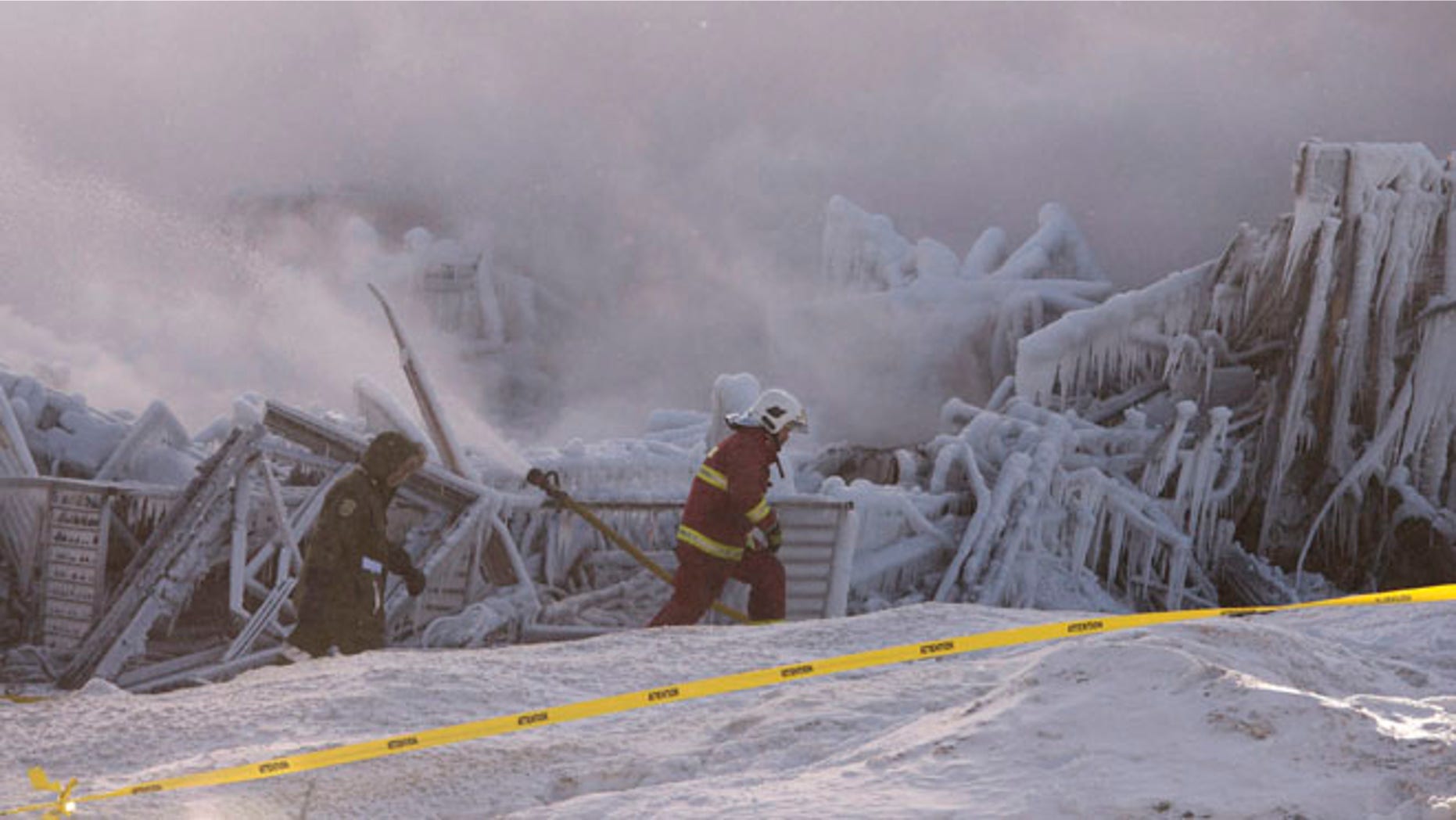 Jan. 23, 2014: Firefighters work at the scene of a senior's residence fire in L'Isle-Verte, Quebec.