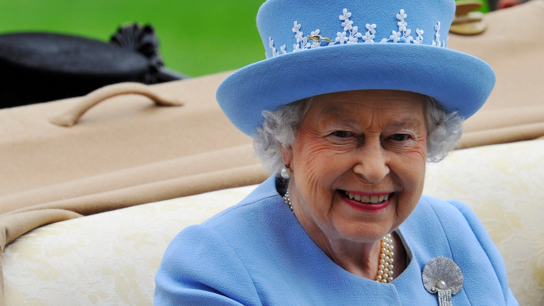 Britain's Queen Elizabeth arrives on the fifth day of the Royal Ascot horse racing festival at Ascot in southern England June 22, 2013