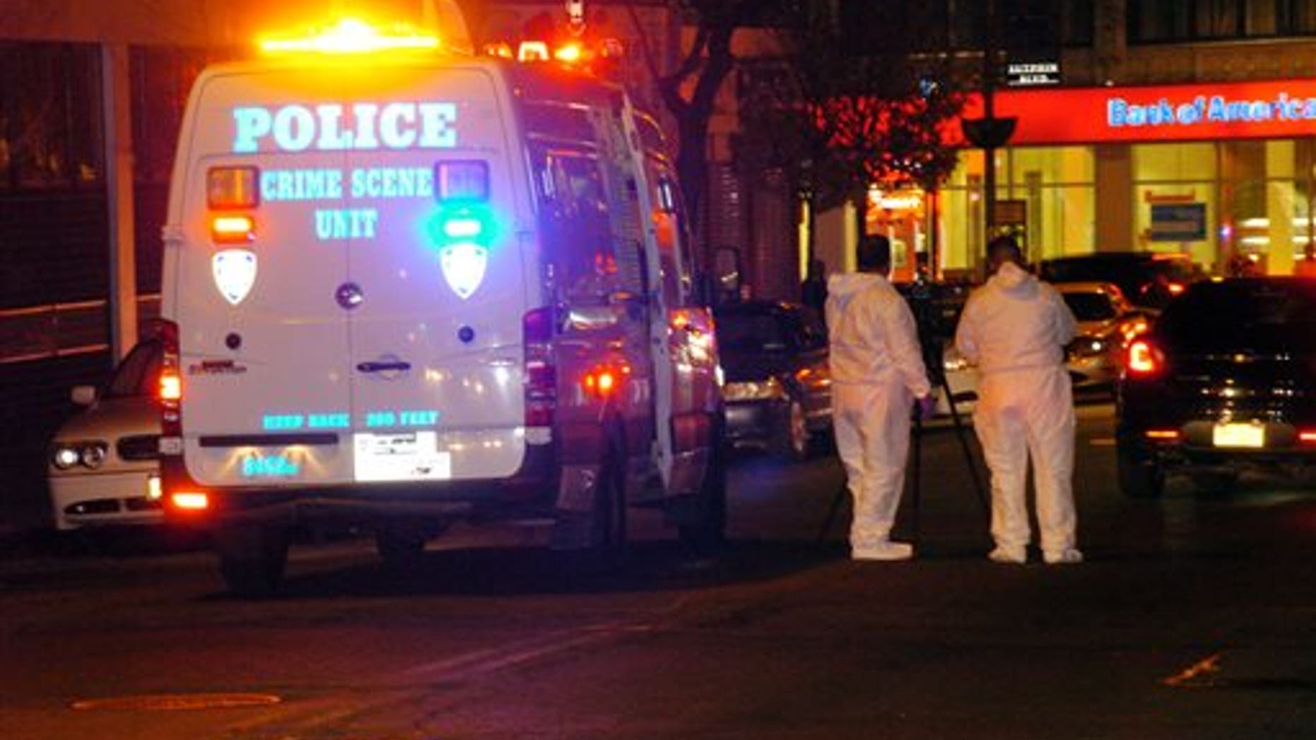 Police are investigating the deaths of a woman and two toddlers in the Queens borough of New York, Sunday, Jan. 19, 2014. Police say the bodies of a 1-year-old child, a 3-year-old child and a 21-year-old female were found in an apartment on Sutphin Blvd. in the Jamaica section of the borough. (AP Photo/David Torres)