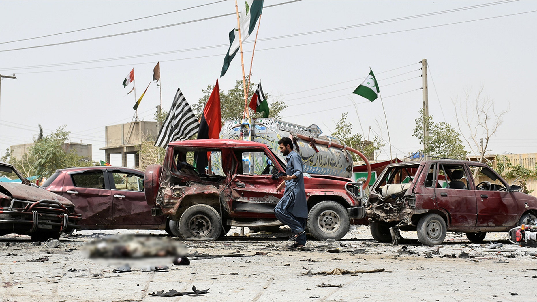 A member of the bomb disposal unit collects evidence from the site and captures the aftermath of a suicide blast in Quetta, Pakistan on July 25.