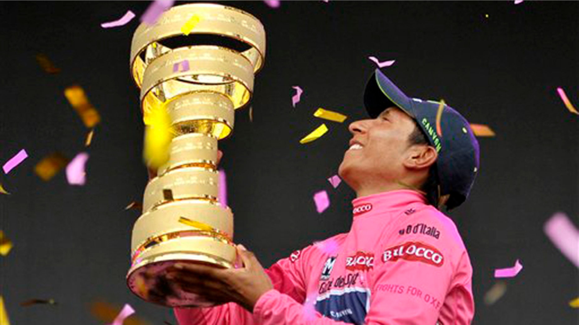 Colombia's Nairo Quintana holds the trophy after winning the Giro D'italia, Tour of Italy cycling race, in Trieste, Italy, Sunday, June 1, 2014. Nairo Quintana confirmed himself as cycling's next star by winning the Giro d'Italia on Sunday to follow his runner-up finish in last year's Tour de France. The 24-year-old climbing specialist with the Movistar team won two stages and finished with a 3 minute, 7 second advantage over fellow Colombian Rigoberto Uran for his first Grand Tour victory. Italy's Fabio Aru finished third overall, 4:04 back. (AP Photo/Marco Alpozzi)