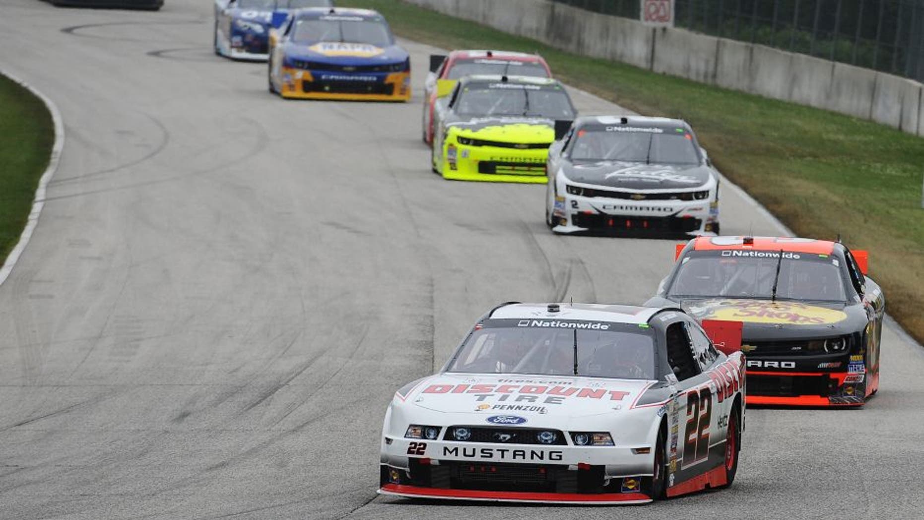 ELKHART LAKE, W.I. - JUNE 21: Alex Tagliani, driver of the #22 Discount Tire Ford, leads a pack of cars during the NASCAR Nationwide Series Gardner Denver 200 Fired Up by Johnsonville at Road America, June 21, 2014 in Elkhart Lake, Wisconsin. (Photo by Rainier Ehrhardt/Getty Images)