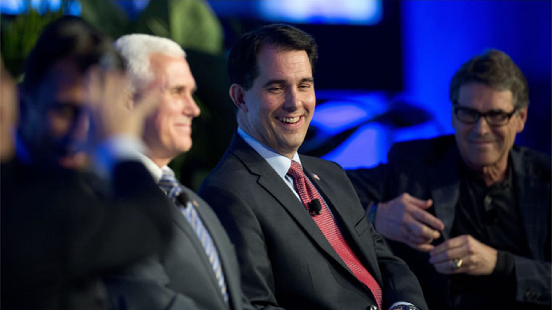 Wednesday, Nov. 19, 2014: Wisconsin Gov. Scott Walker, center; Indiana Gov. Mike Pence, left, and Texas Gov. Rick Perry in Boca Raton, Fla.
