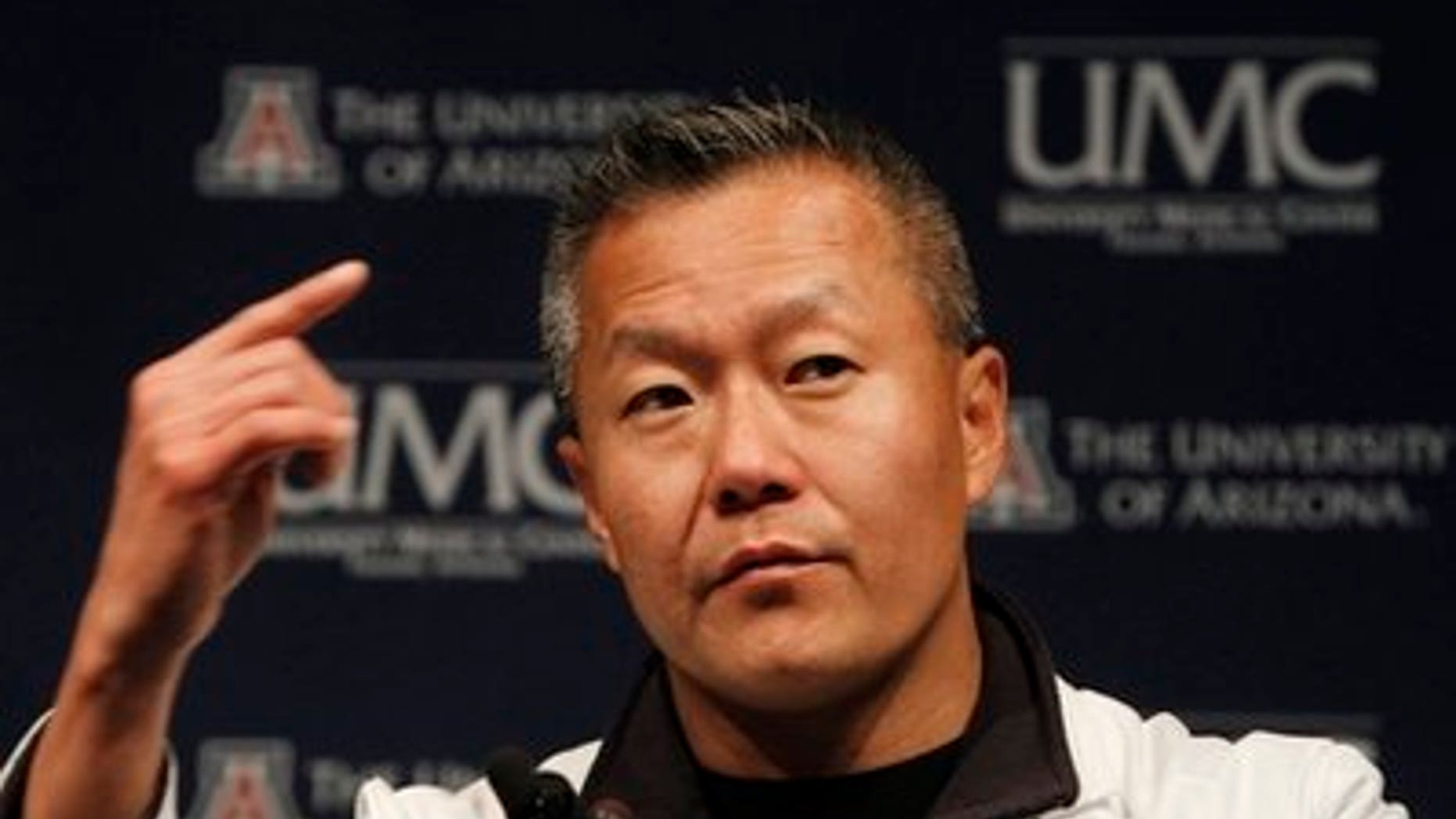 FILE - In this Jan. 11, 2011 file photo, Dr. Peter Rhee, Trauma and Critical Care Emergency Surgery doctor at University Medical Center, describes in more detail the gunshot wound Rep. Gabrielle Giffords, D-Ariz.,received on Saturday, during a news briefing at UMC in Tucson, Ariz. Giffords remains in critical condition, but doctors have reported steady progress each day since she was wounded last weekend. If all goes well, she may be "out of the woods" on Friday, said Rhee. (AP Photo/Ross D. Franklin, File)