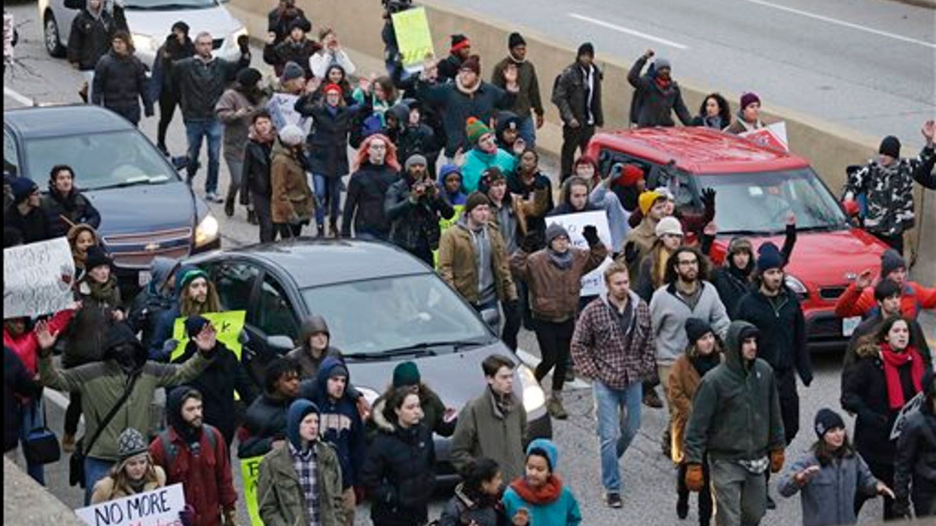 In this Nov. 25, 2014, photo, protesters block cars on the freeway during a protest over the police shooting of Tamir Rice in Cleveland. (AP Photo/Tony Dejak, File)