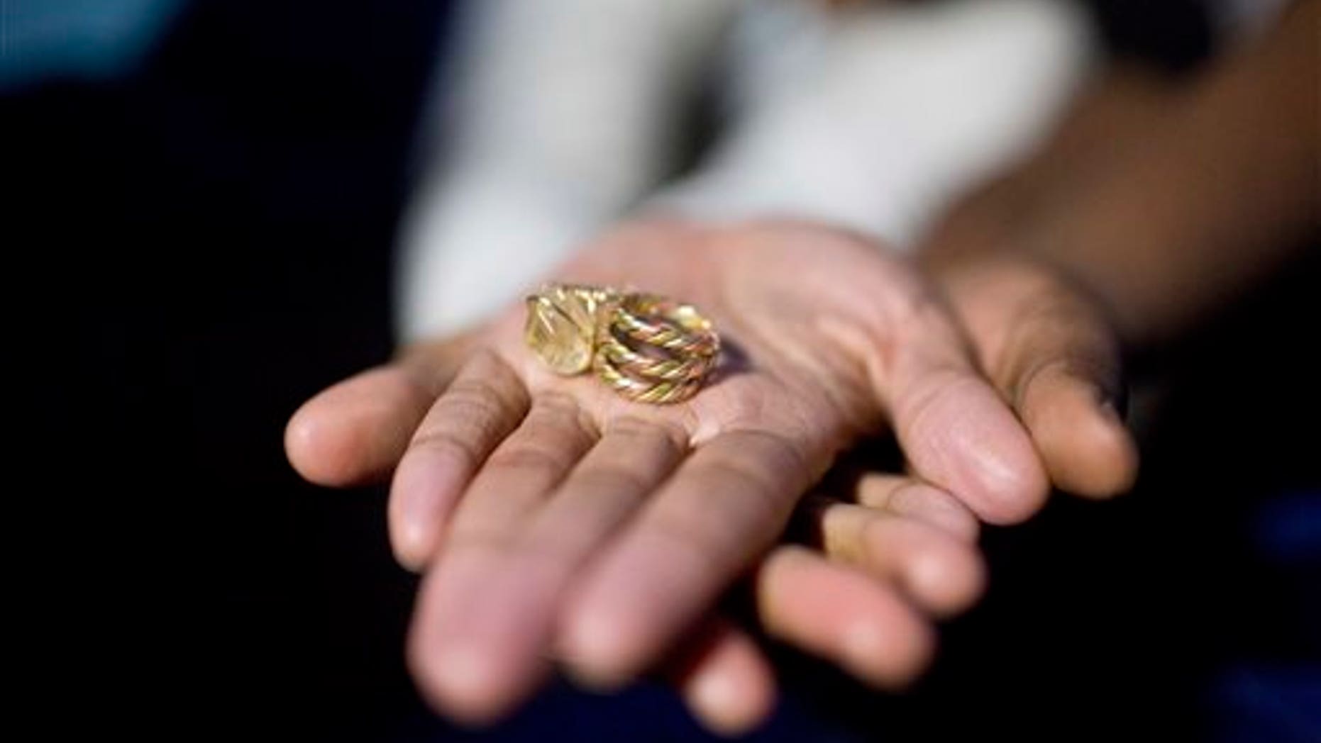 Tori Sisson holds out her and Shanté Wolfe's wedding rings inside their tent near the Montgomery County Courthouse Sunday, Feb. 8, 2015, in Montgomery, Ala. (AP Photo/Brynn Anderson)