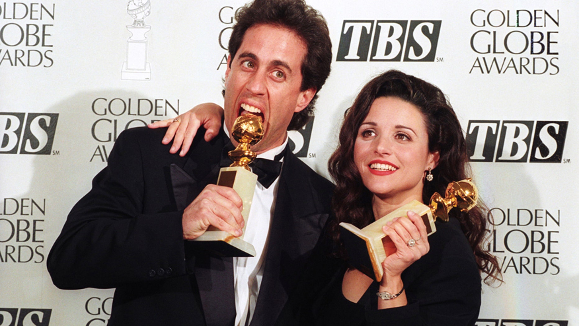 Jerry Seinfeld and Julia Louis-Dreyfus show their Golden Globe awards January 22, 1994.