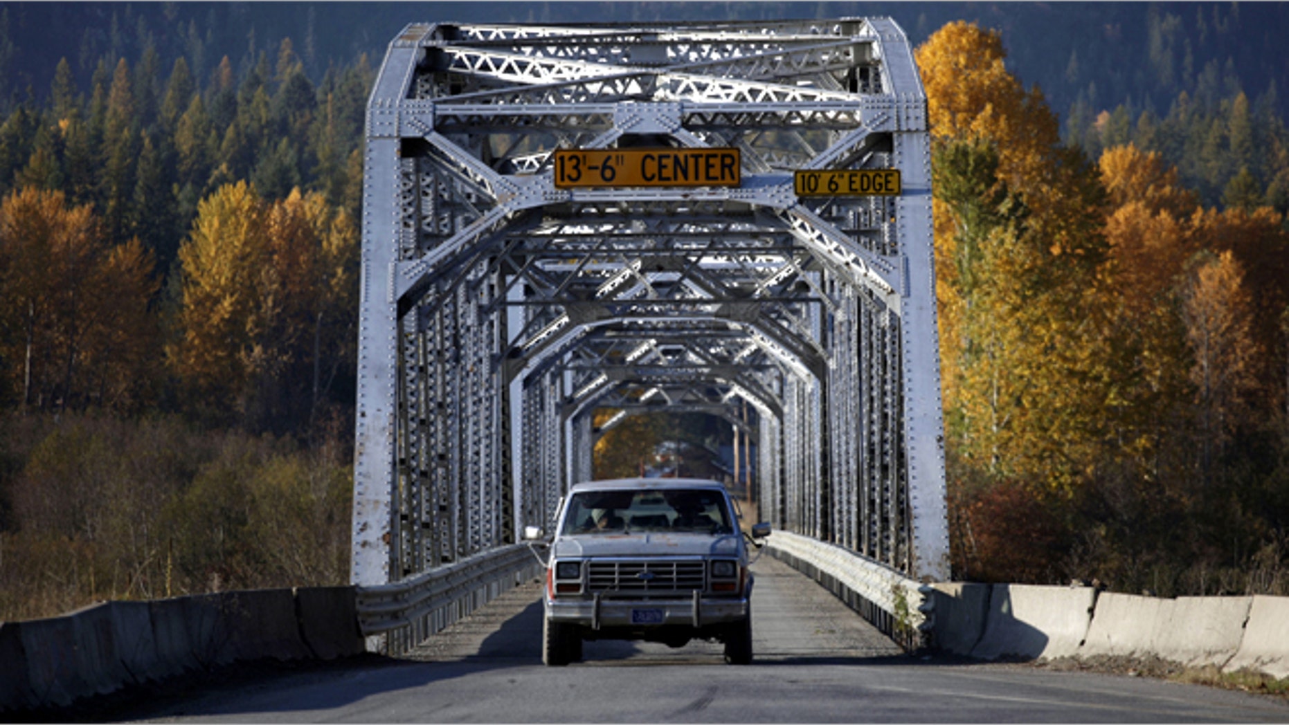 A truck is driven across a one-lane bridge across the Clark Fork River in Noxon, Montana. (REUTERS)
