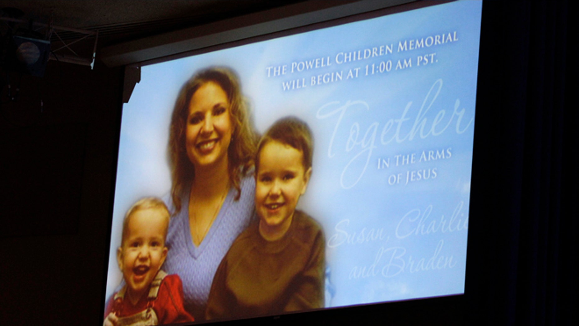 A picture of Susan Powell is seen on a screen with her children Charles (R) and Braden Powell during funeral services for the boys in Tacoma, Wash., Feb. 11, 2012.