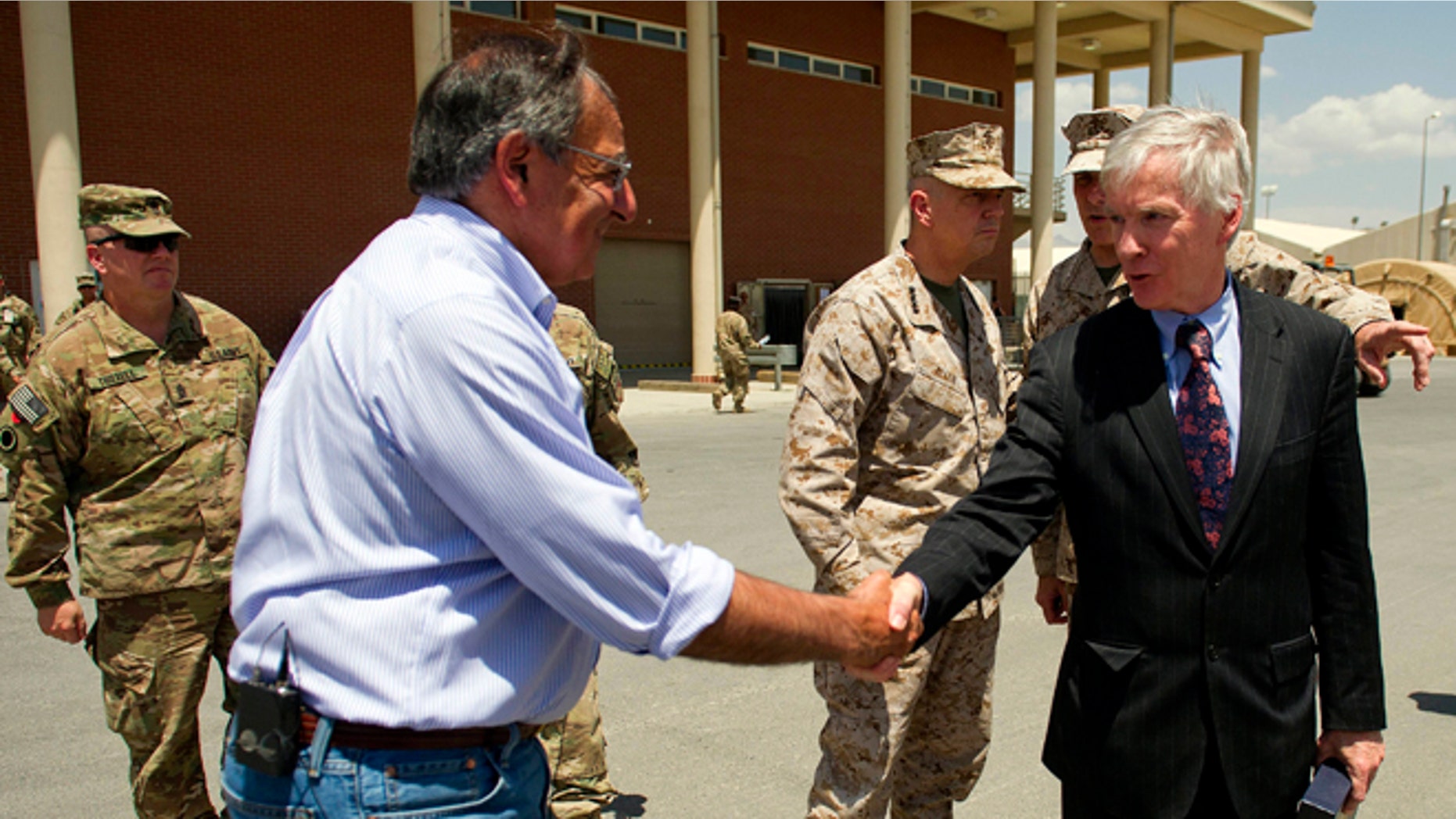 June 7, 2012: US Ambassador to Afghanistan Ryan Crocker, right, shakes hands with US Secretary of Defense Leon Panetta before departing Kabul International Airport.