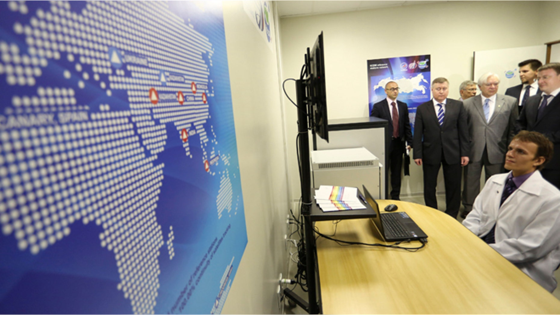 Russian Federal Space Agency (ROSCOSMOS) deputy head Sergey Saveliev (2nd L) and Brazilian Space Agency head Jose Raimundo Coelho (4th L, light suit) preside over the inauguration of the first monitoring station of Russia's GLONASS global navigation system outside of Russia, on the University of Brasilia campus in Brasilia February 19, 2013.