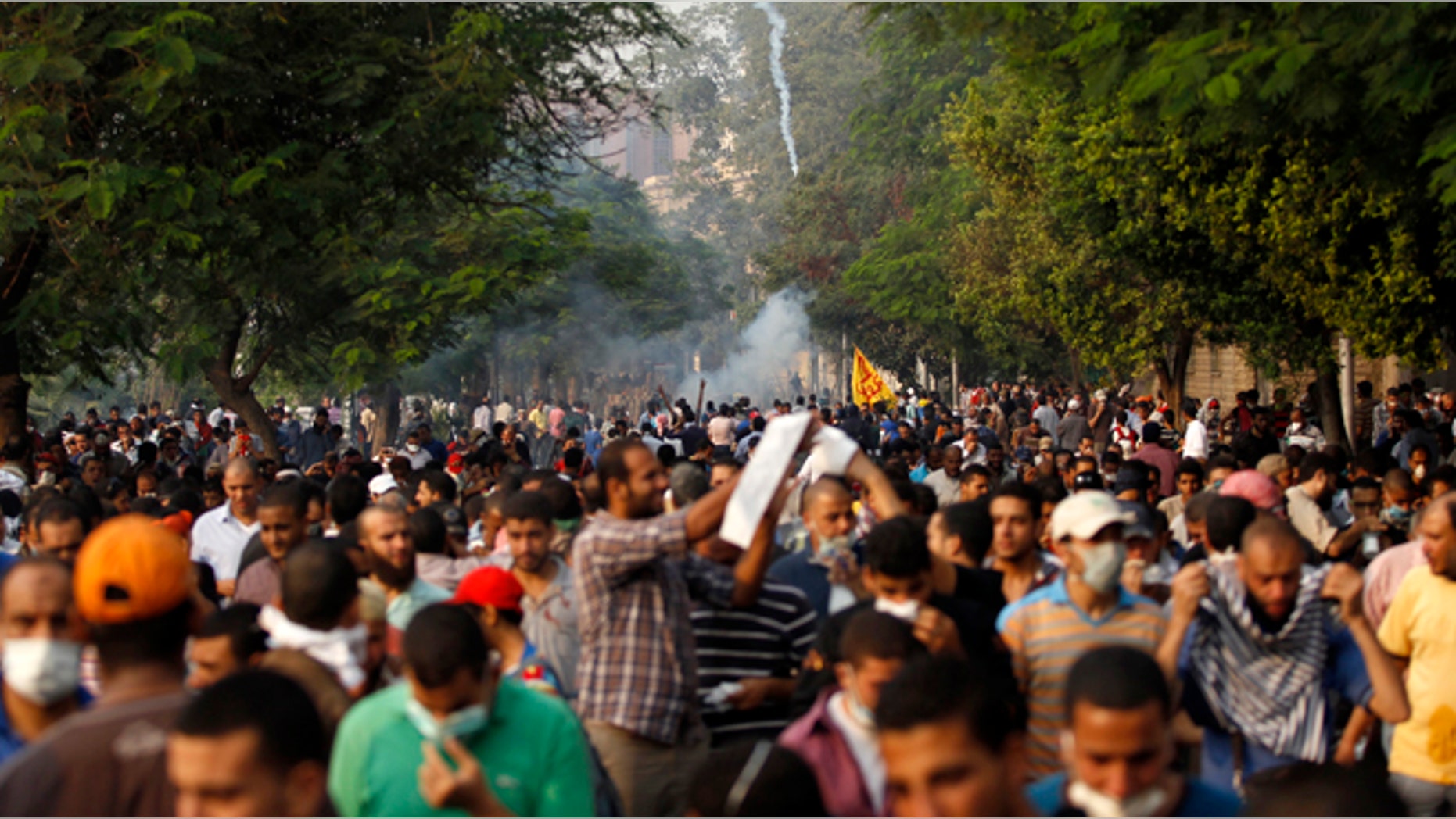 Members of the Muslim Brotherhood and supporters of ousted Egyptian President Mohamed Mursi run from tear gas released by riot police during clashes along a road at Kornish El Nile which leads to Tahrir Square during a celebration commemorating Egypt's 1973 war with Israel in Cairo October 6, 2013.