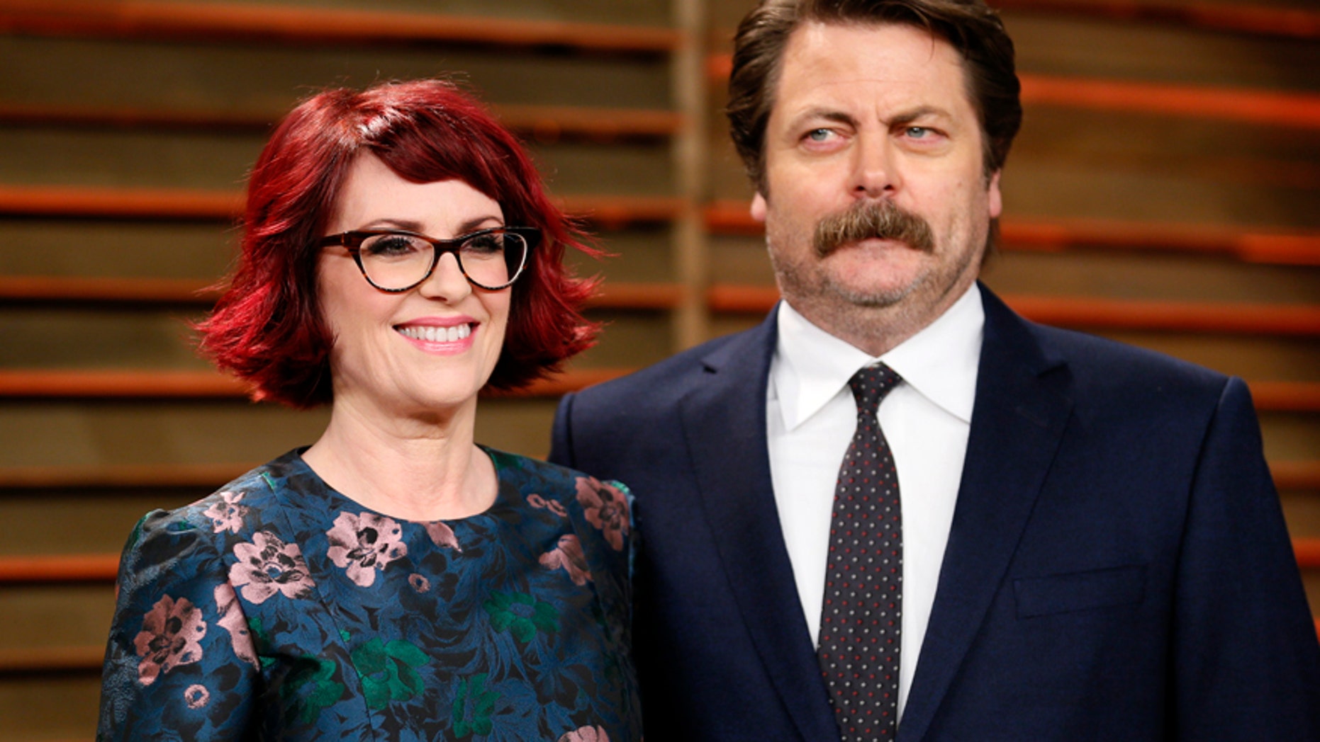 Actress Megan Mullally and actor Nick Offerman arrive at the 2014 Vanity Fair Oscars Party in West Hollywood, California March 2, 2014.