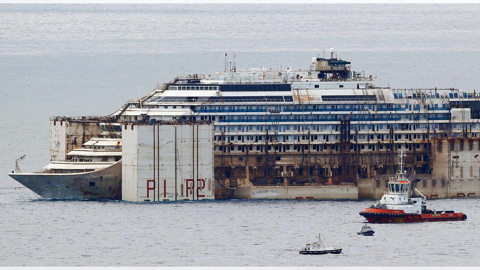 July 27, 2014 - FILE photo of tug boats towing the Costa Concordia ship outside Genoa's port, in northern Italy, where the ship is being broken up for scrap. The company dismantling the ship says workers have discovered human remains believed to be that of the last missing crew member.