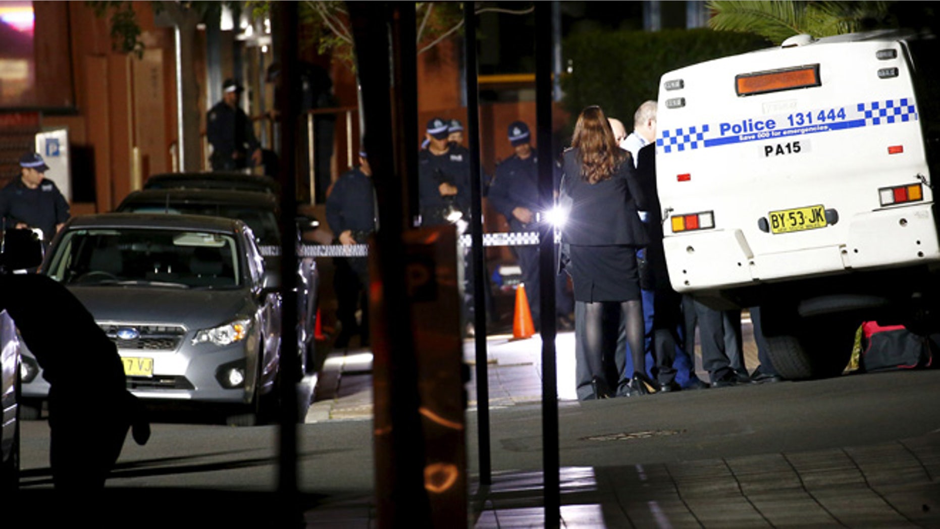 Oct. 2, 2015: Police stand guard and inspect the area outside the New South Wales state police headquarters located in the Sydney suburb of Parramatta, Australia.