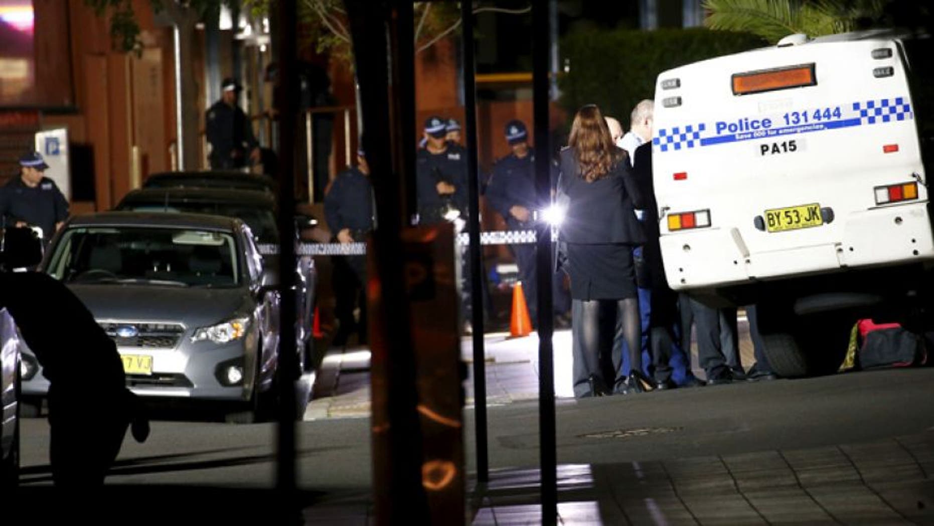 Oct. 2, 2015: Police stand guard and inspect the area outside the New South Wales state police headquarters located in the Sydney suburb of Parramatta, Australia.