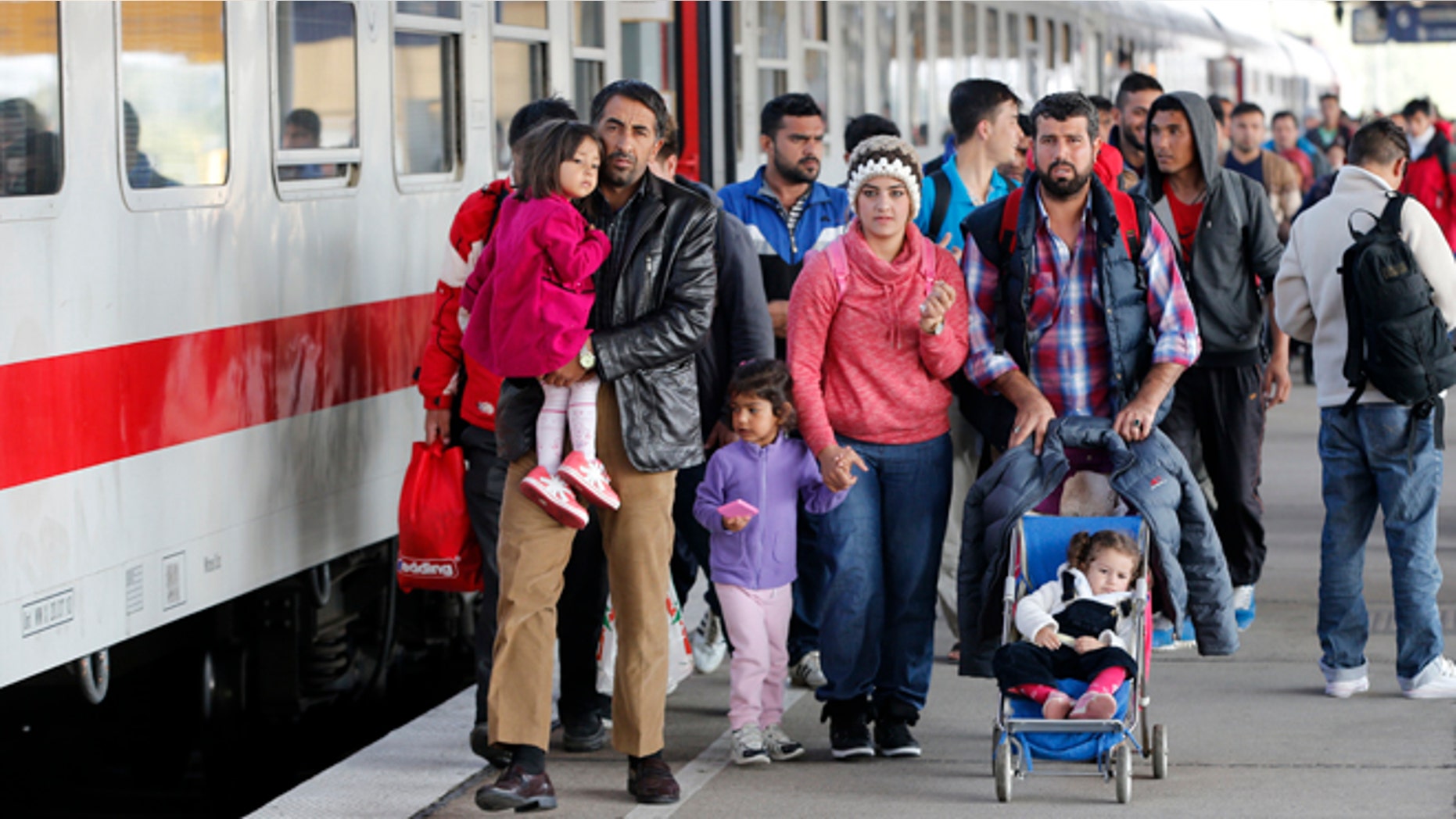 Oct. 5, 2015: Refugees from Syria walk along a platform after arriving from Salzburg, Austria, at Schoenefeld railway station in Berlin, Germany.