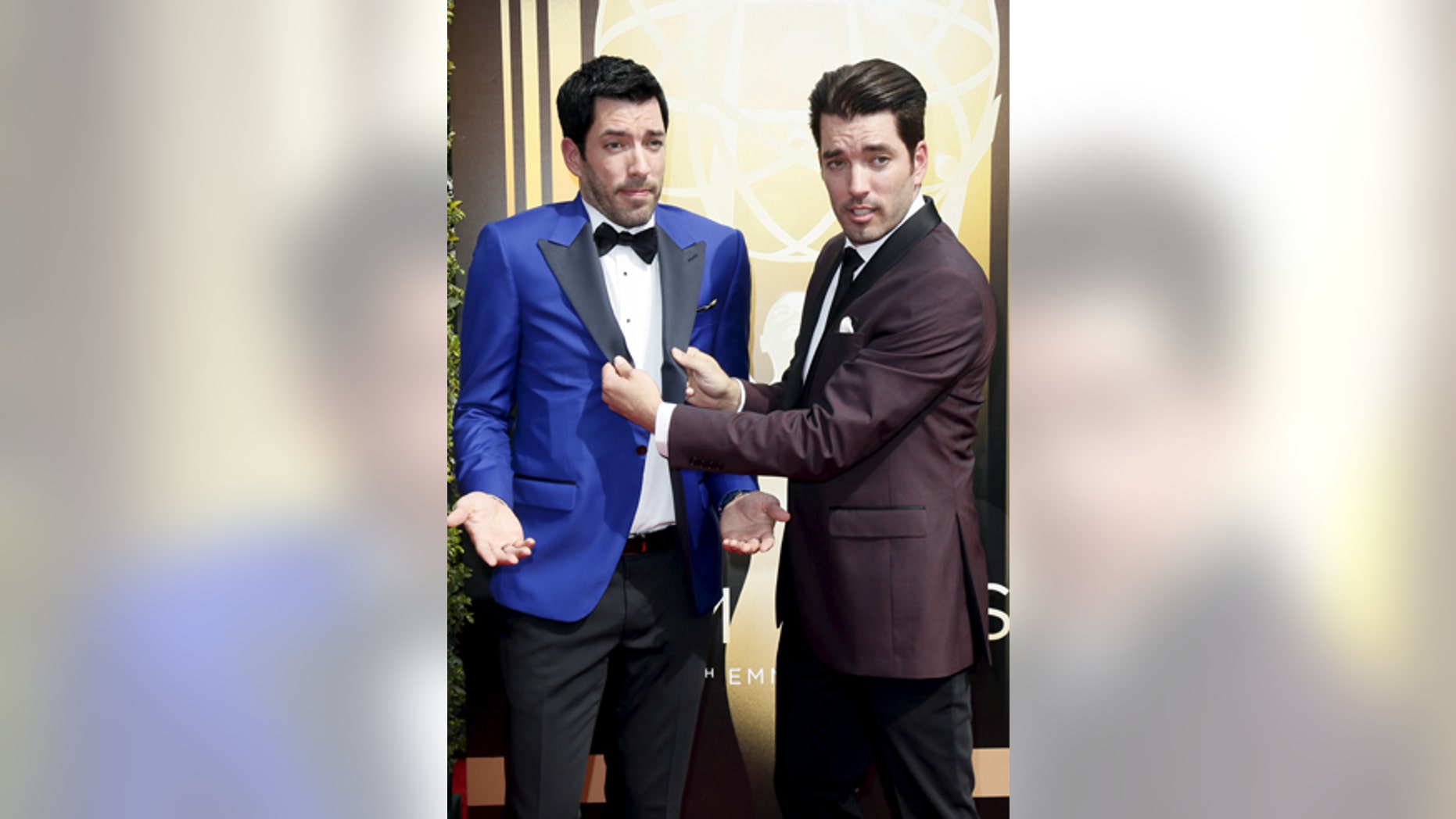 Television personalities Drew Scott (L) and twin brother Jonathan Scott pose at the 2015 Creative Arts Emmy Awards in Los Angeles, California September 12, 2015.