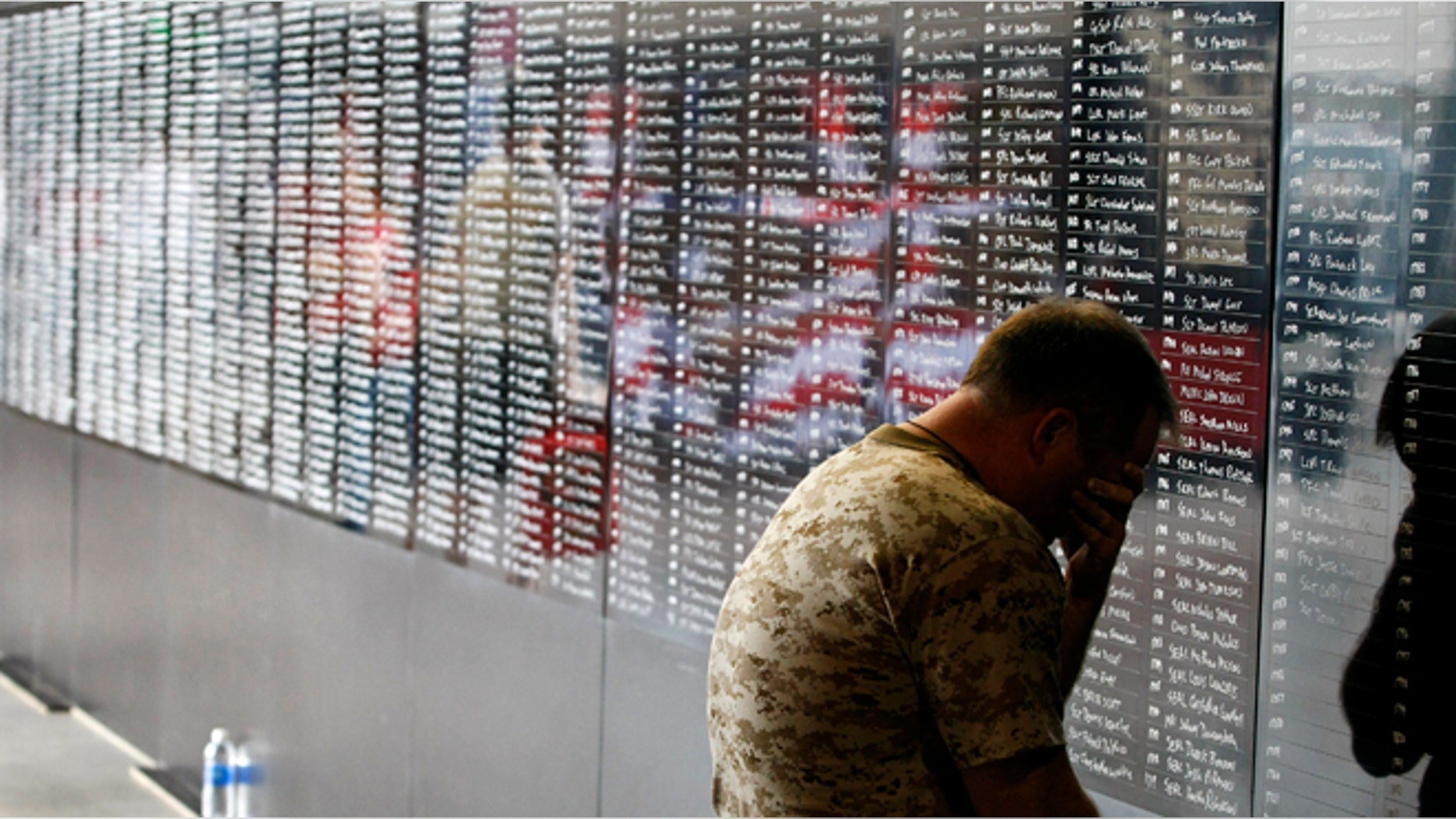 Two-time Memory Champion and U.S. Navy veteran Ron White pauses to reflect for a moment as he adds the names of over 2,000 fallen military personnel who served in the war in Afghanistan.