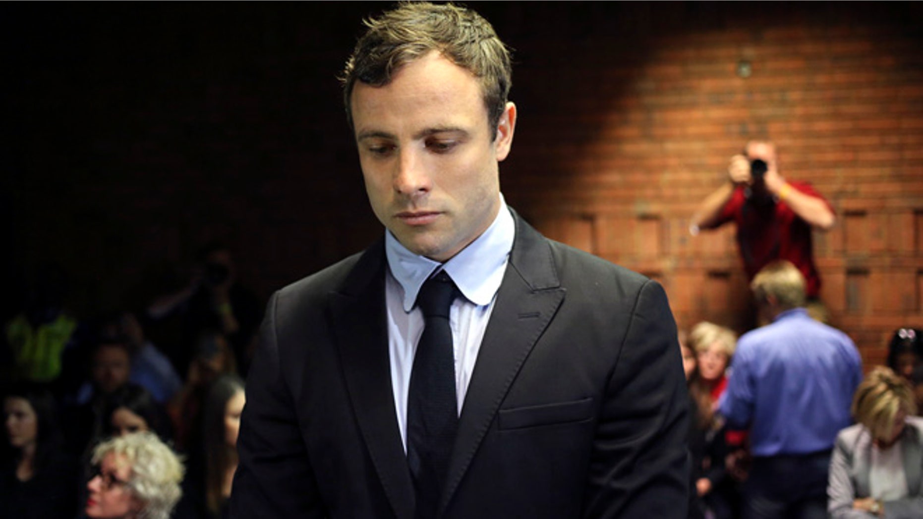 August 19, 2013: Olympic and Paralympic running star Oscar Pistorius stands during court proceedings at the Pretoria Magistrates court.