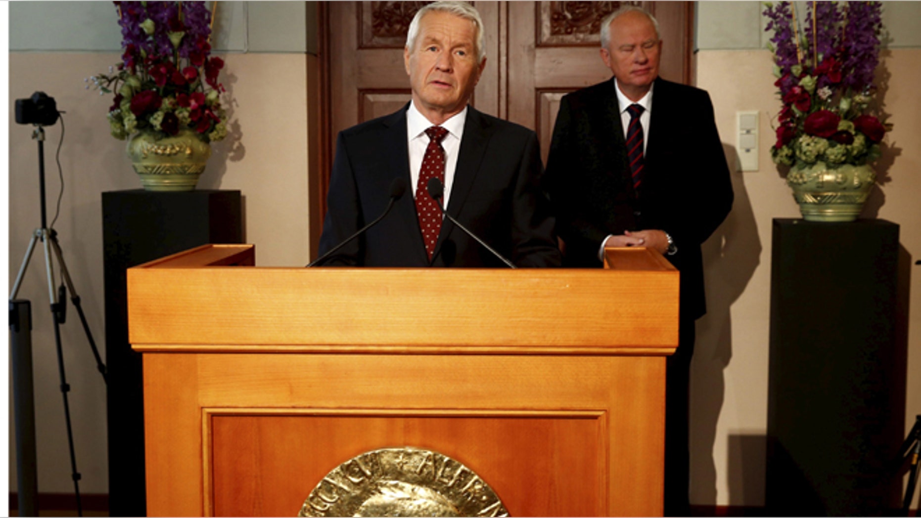 Chairman of the Norwegian Nobel Committee Thorbjorn Jagland announces the winner of the Nobel Peace Prize as committee secretary Geir Lundestad listens at the Nobel Institute in Oslo October 11, 2013.