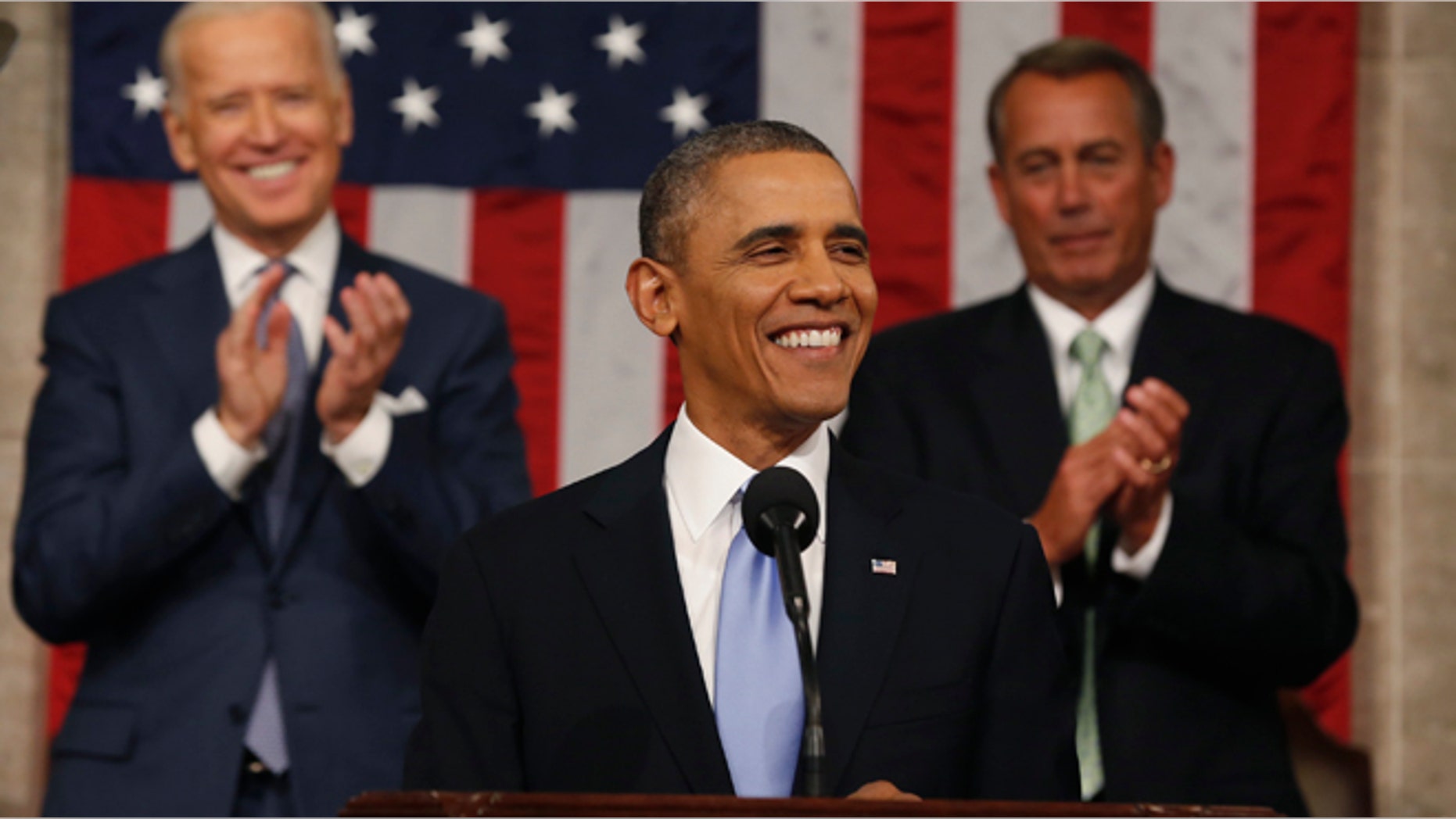 Vice President Joe Biden (L) and Speaker of the House John Boehner applaud as President Barack Obama finishes his State of the Union speech on Capitol Hill in Washington, January 28, 2014.