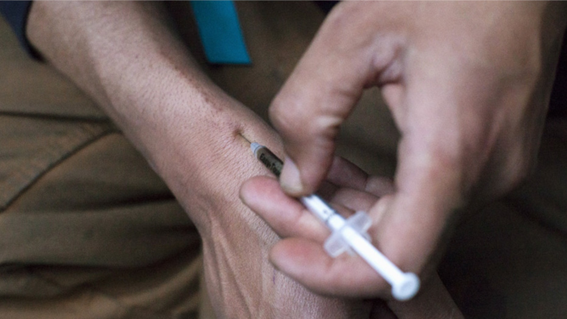 May 14, 2015: A man injects himself with heroin using a needle.