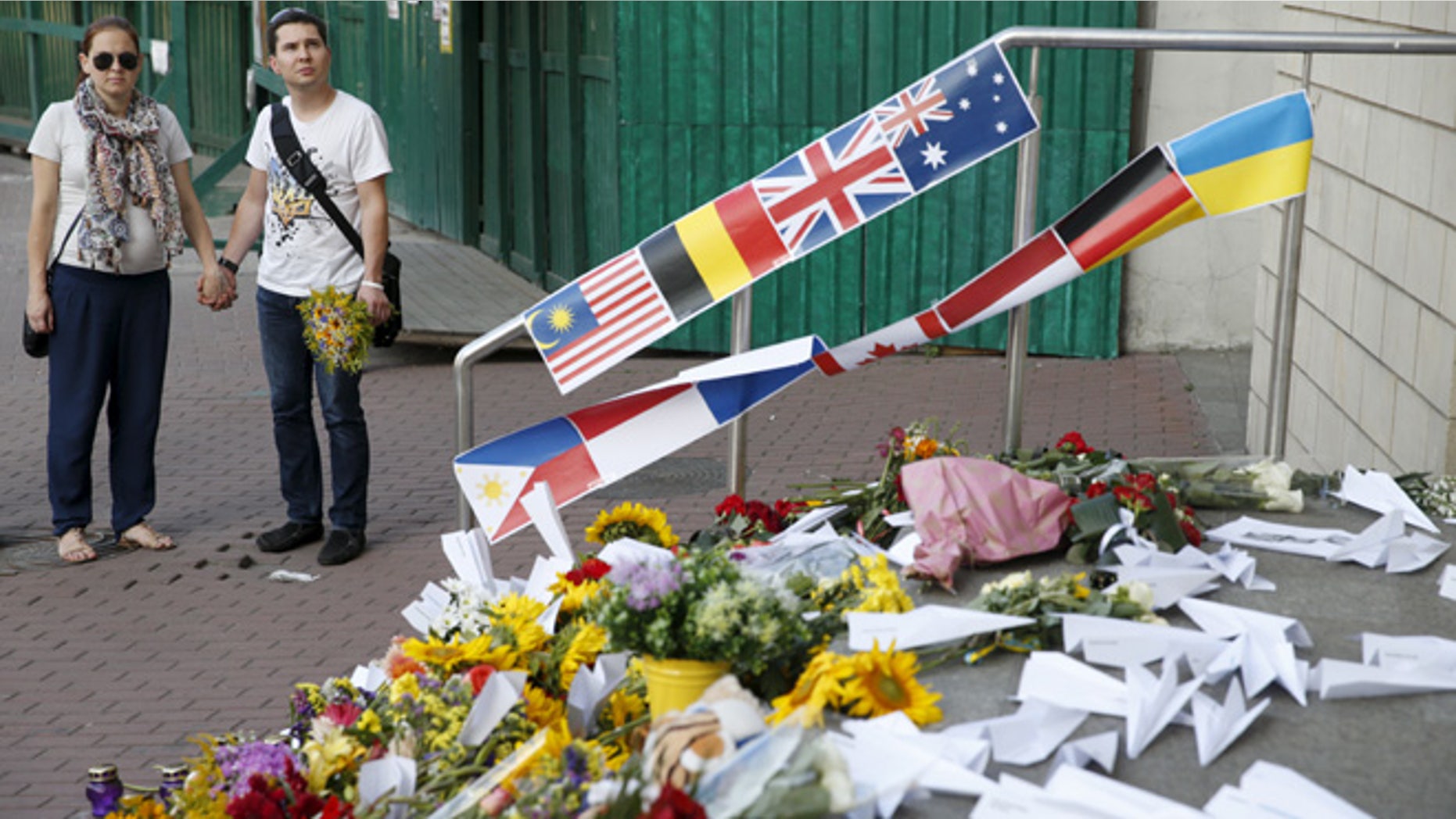 July 17, 2015: People gather outside the Dutch embassy to commemorate the victims of the Malaysia Airlines flight MH17 plane crash in 2014 in Kiev, Ukraine.