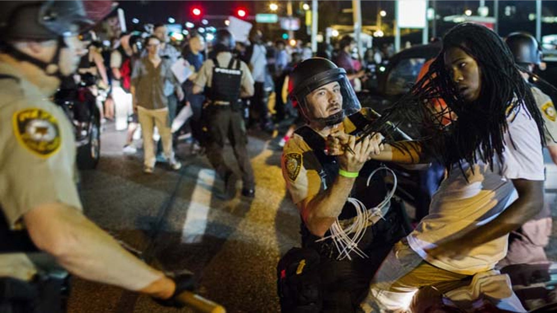 Aug. 10, 2015: St Louis County police officers hold an anti-police demonstrator in Ferguson, Missouri.
