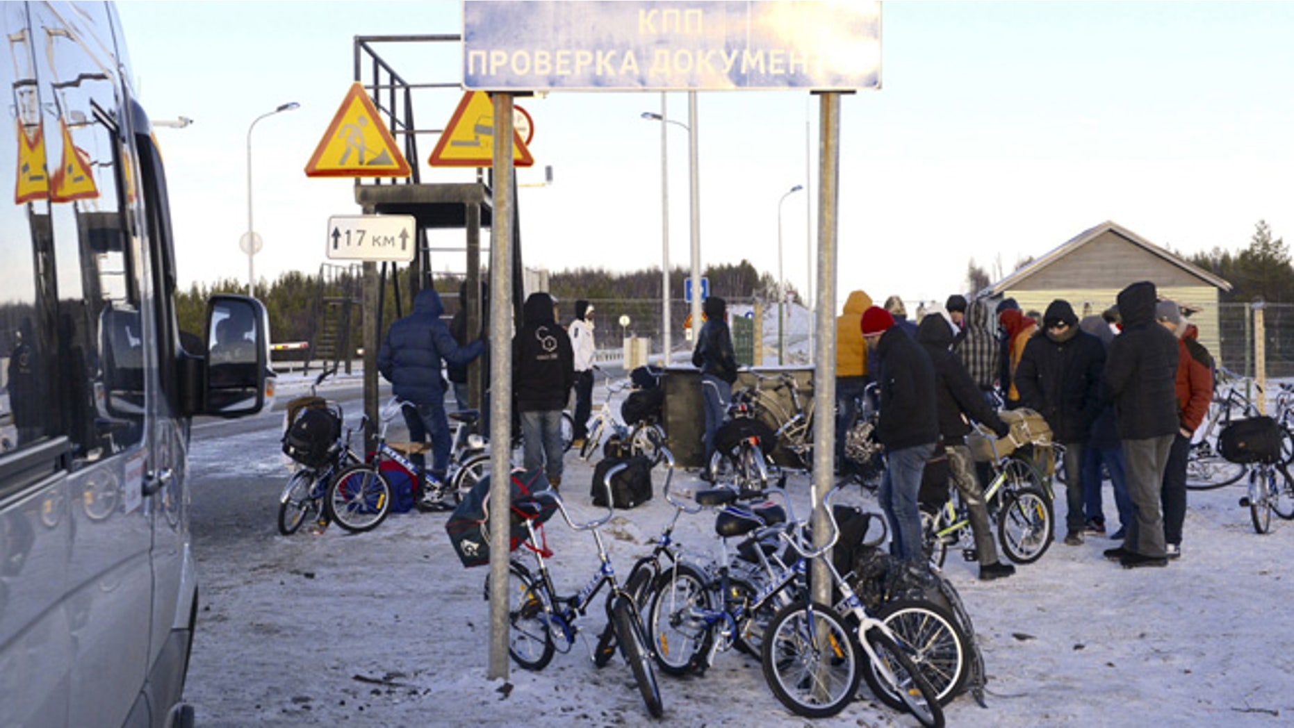 Oct. 30, 2015: Refugees and migrants gather near a check point on the Russian-Norwegian border.
